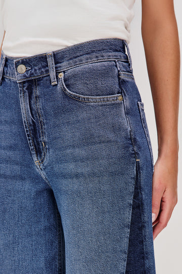 Angeleno is a mid rise 5-pocket, wide leg jean with a contrast godet in Indigo Grove colorway, a medium blue wash. Front detail view featured on model.