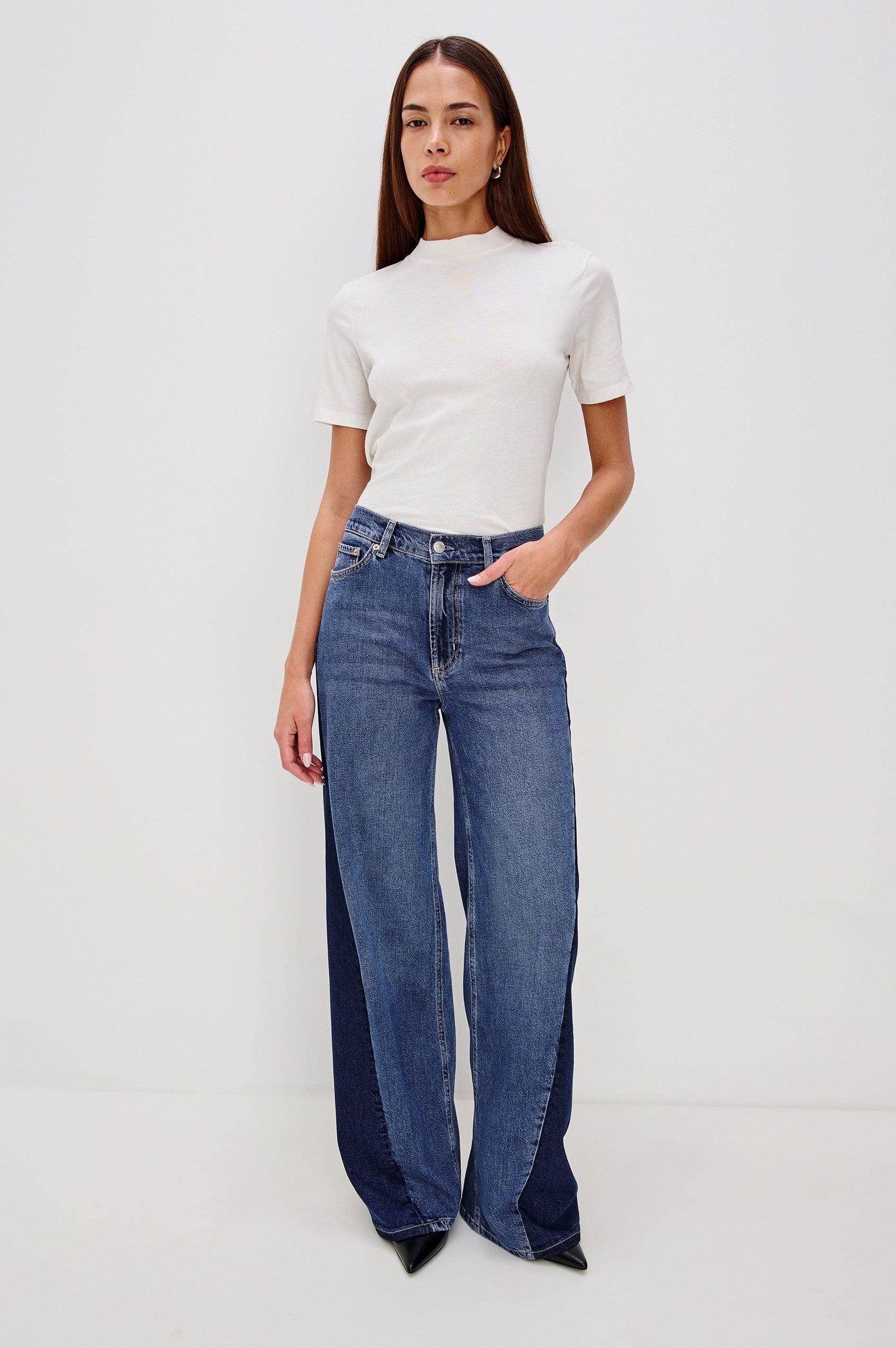 Angeleno is a mid rise 5-pocket, wide leg jean with a contrast godet in Indigo Grove colorway, a medium blue wash. Front full body view featured on model.