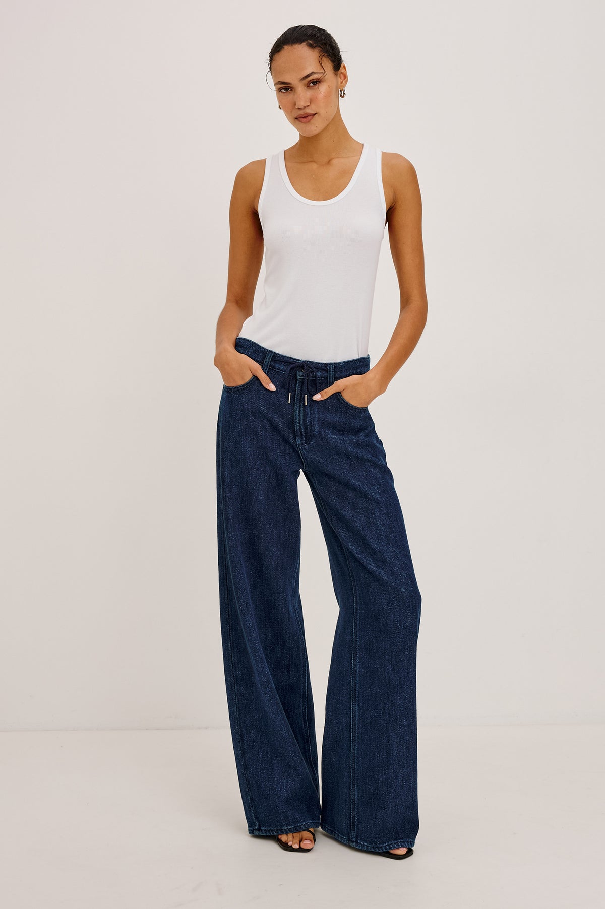 Angeleno Wide Leg Jean With Mid-Rise Relaxed Fit, Wide Legs, Drawstring Waist Ties, Hidden Stretch, and 5-Pockets in Imperial Blue Colorway - Full Body Front View Featured on Model