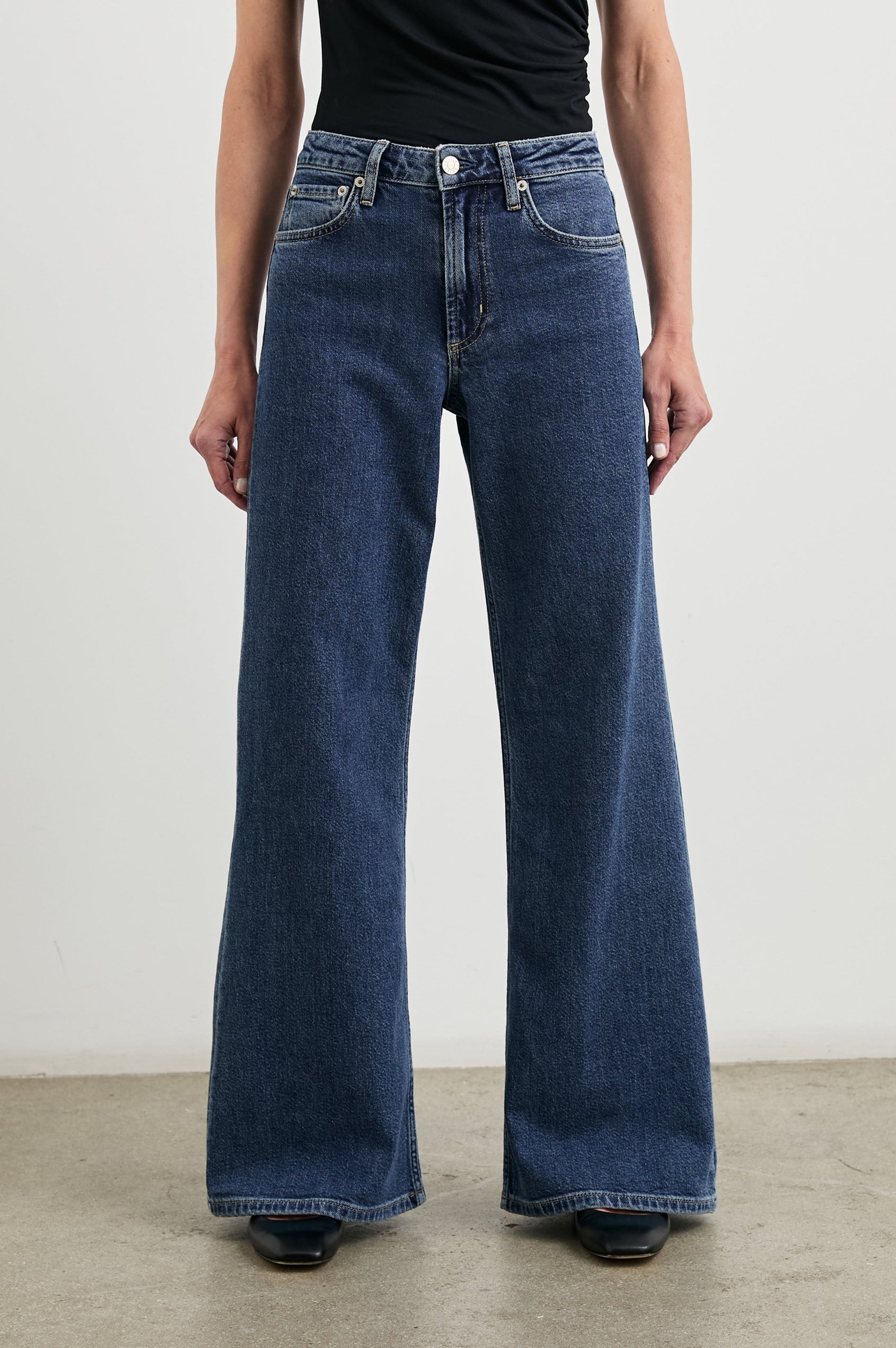 Angeleno Wide Leg Denim Pants with Belt Loops, Two Front Pockets and Two Back Patch Pockets in Pebble Blue Colorway - Front View Featured on Model