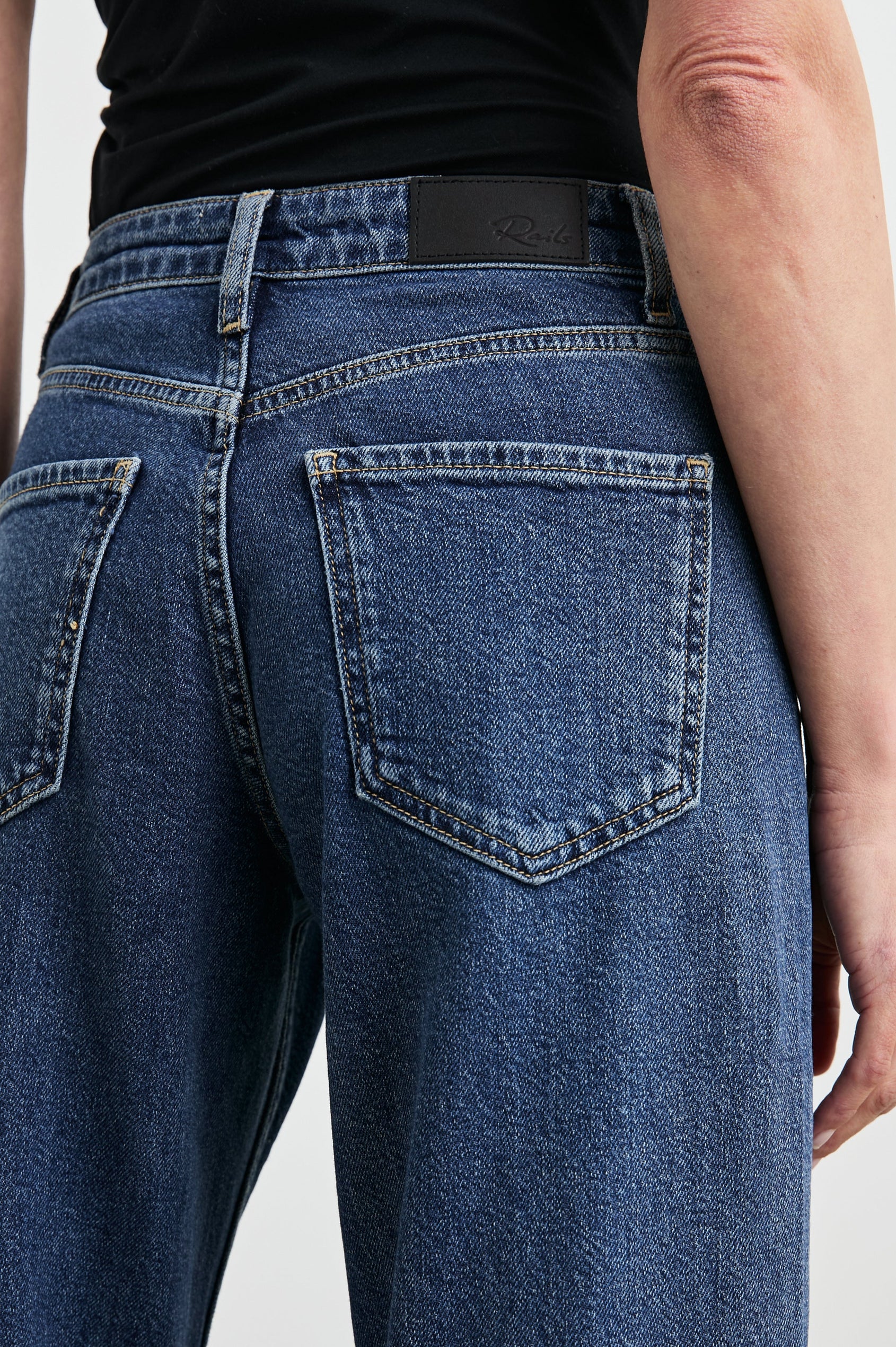 Angeleno Wide Leg Denim Pants with Belt Loops, Two Front Pockets and Two Back Patch Pockets in Pebble Blue Colorway - Back View Featured on Model