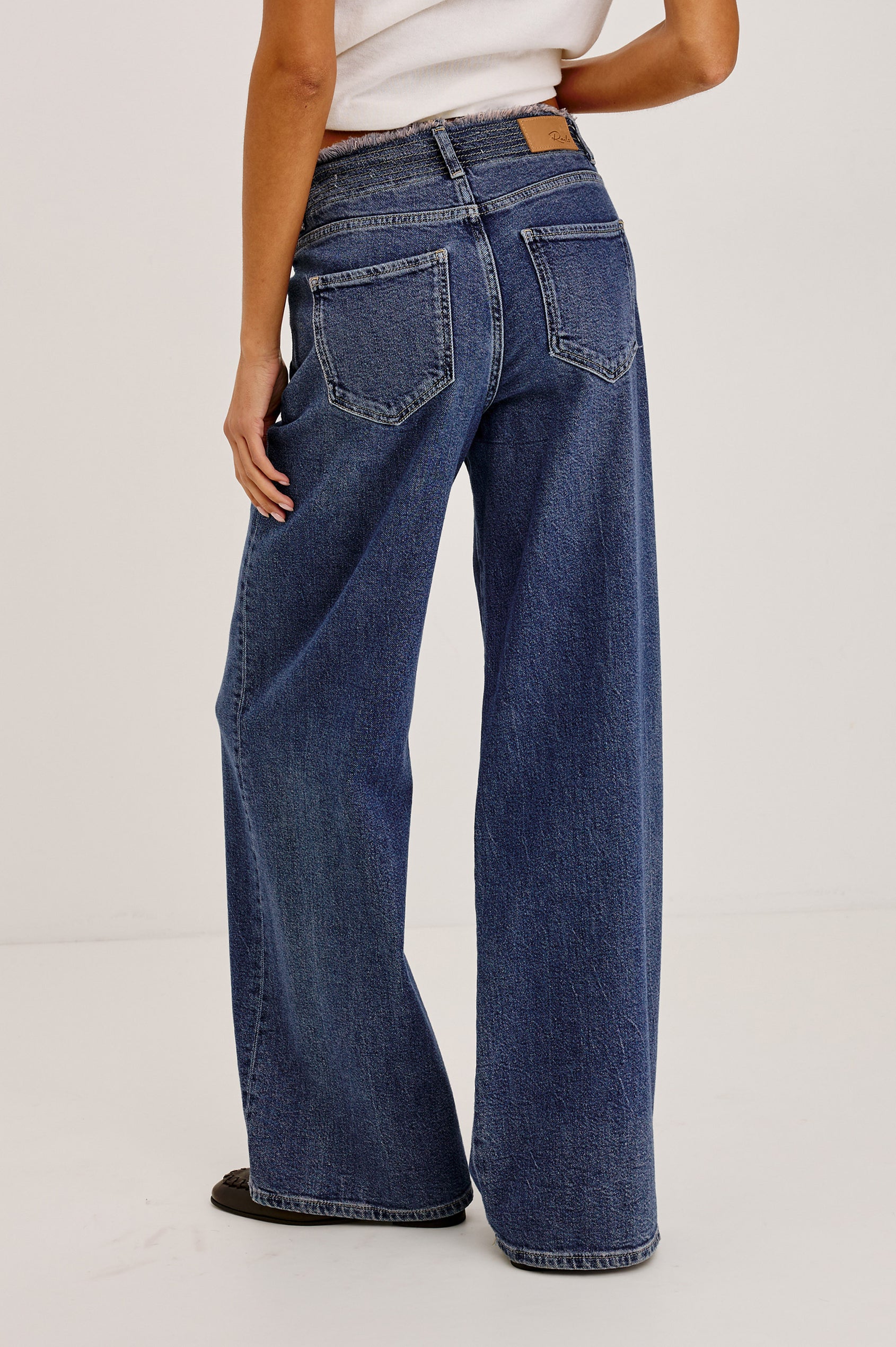 Angeleno Wide Leg in Rigid Denim With Hidden Stretch, Relaxed Mid-Rise Fit, 5-Pockets, Self-Tie Shoelace Belt, and Frayed Waistband in River Colorway - Lower Body Back View Featured on Model