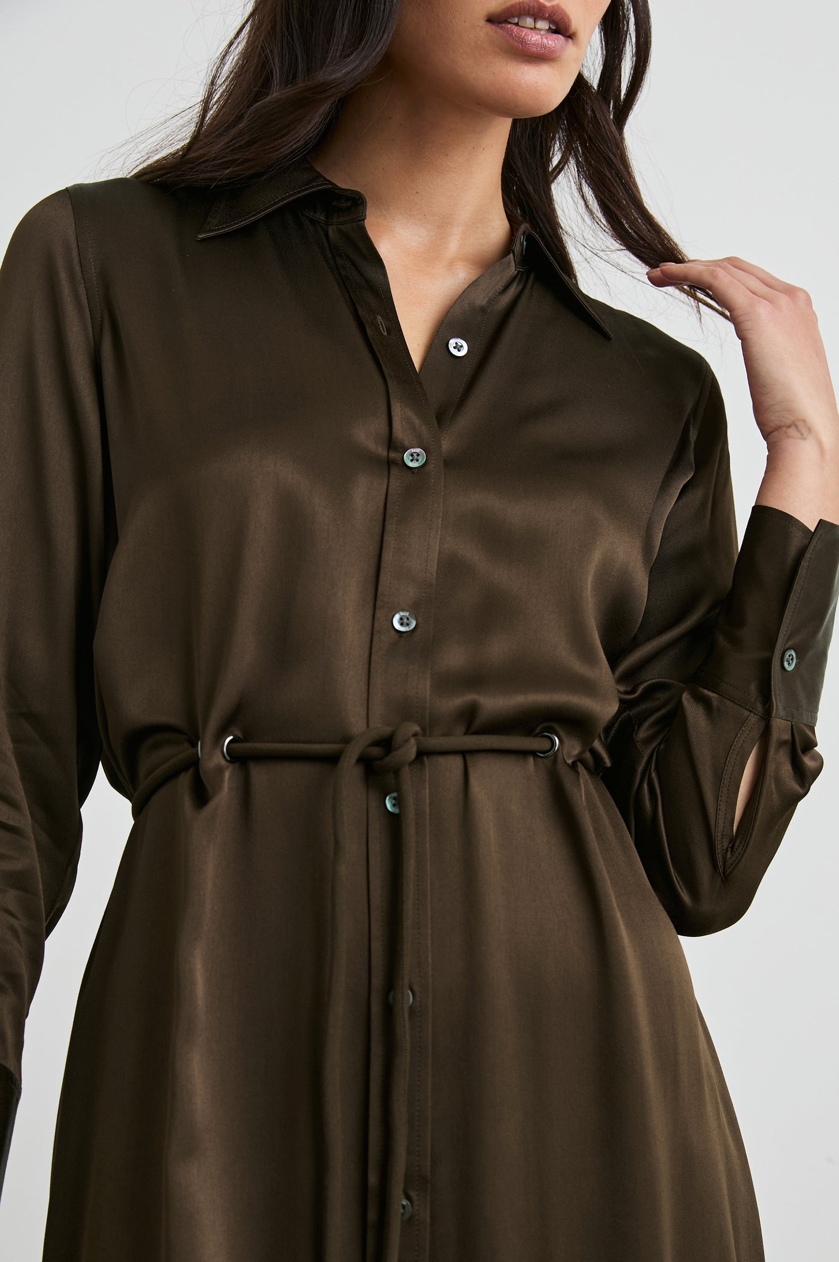 Anina Long-Sleeve Midi Dress with Buttons Down the Front, a Collar, Button Cuffs, and a Cord Belt in Dark Moss Colorway - Front View Featured on Seated Model