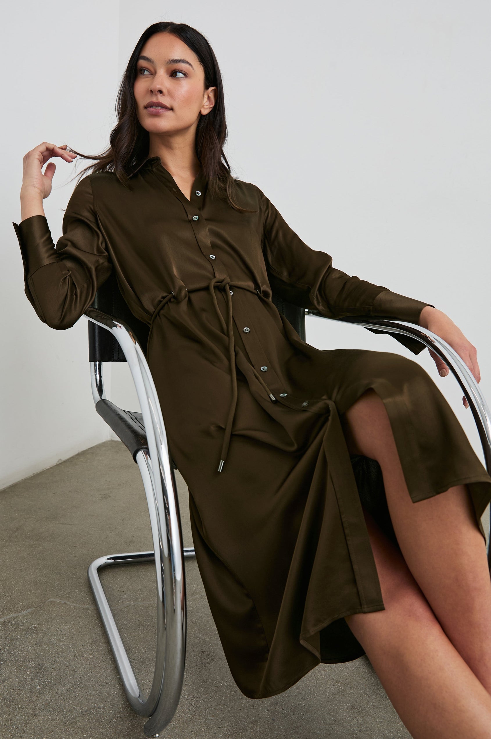 Anina Long-Sleeve Midi Dress with Buttons Down the Front, a Collar, Button Cuffs, and a Cord Belt in Dark Moss Colorway - Front Full Body View Featured on Seated Model