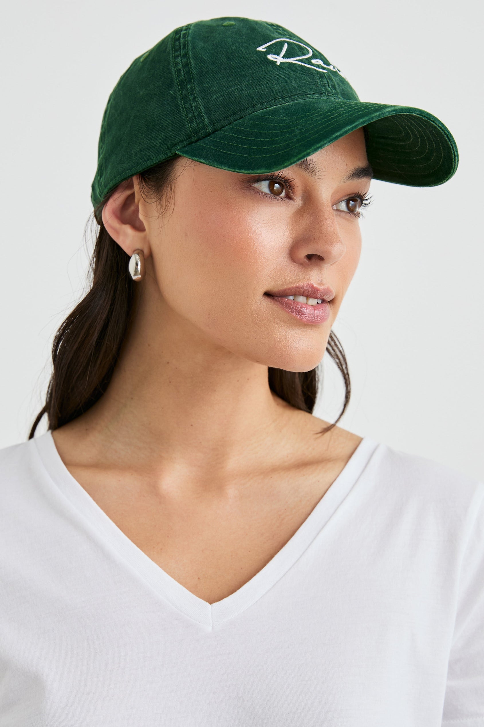 Anniversary Baseball Cap with an Adjustable Back Strap, Front Text, Rails, and Back Text, Est 2009, in Forest Colorway, with White Text - Front View Featured on Model