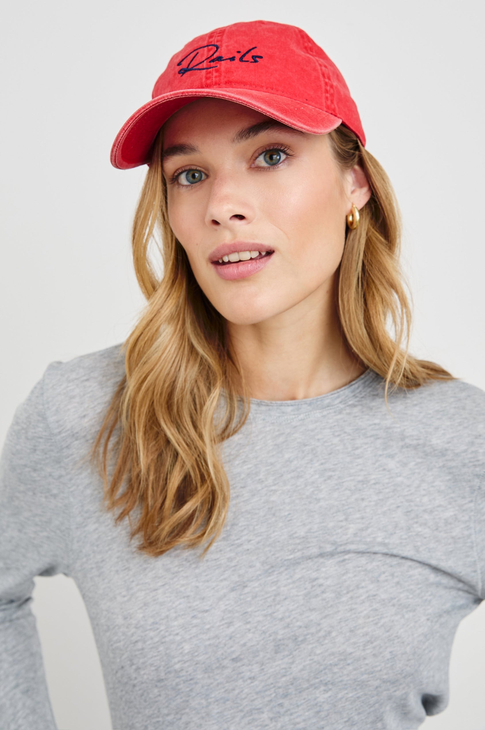 Anniversary Baseball Cap with an Adjustable Back Strap, Front Text, Rails, and Back Text, Est 2009, in Washed Red Colorway, with Blue Text - Front View Featured on Model