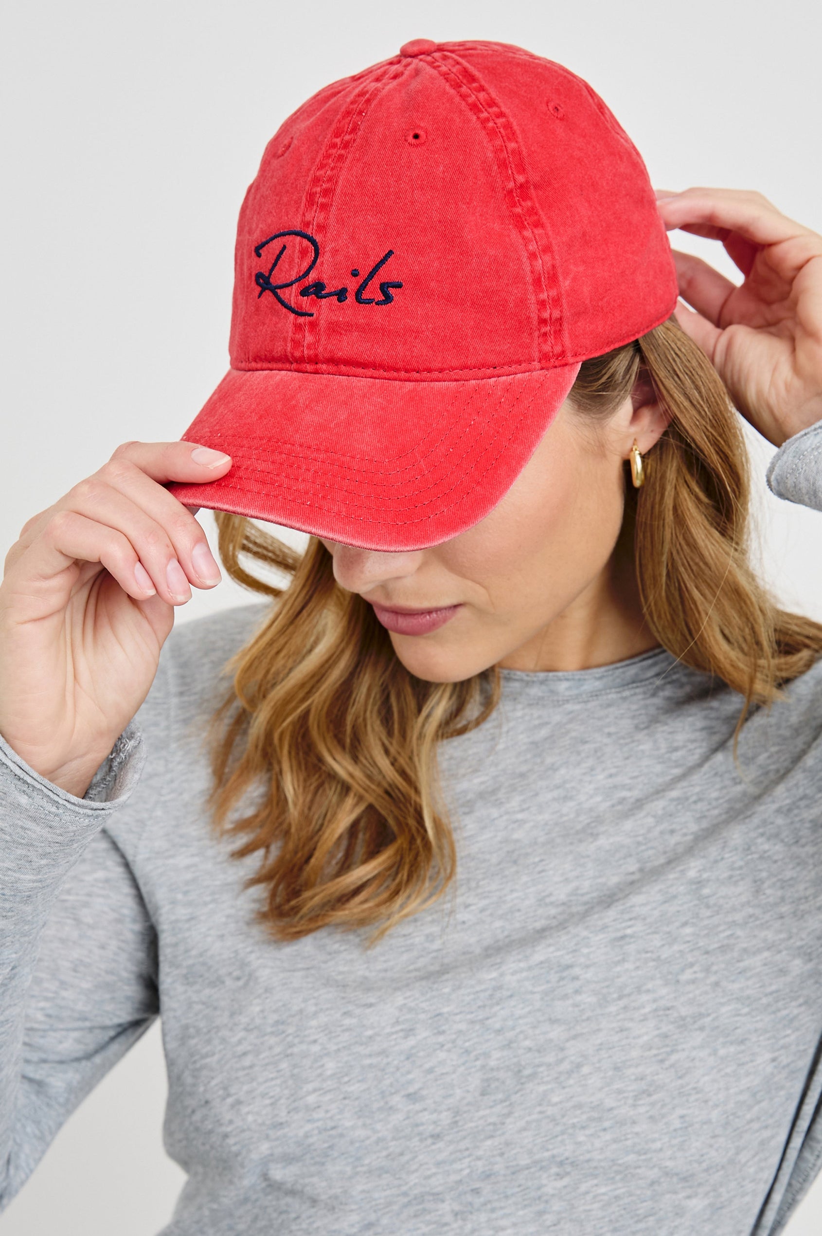 Anniversary Baseball Cap with an Adjustable Back Strap, Front Text, Rails, and Back Text, Est 2009, in Washed Red Colorway, with Blue Text - Front View Featured on Model