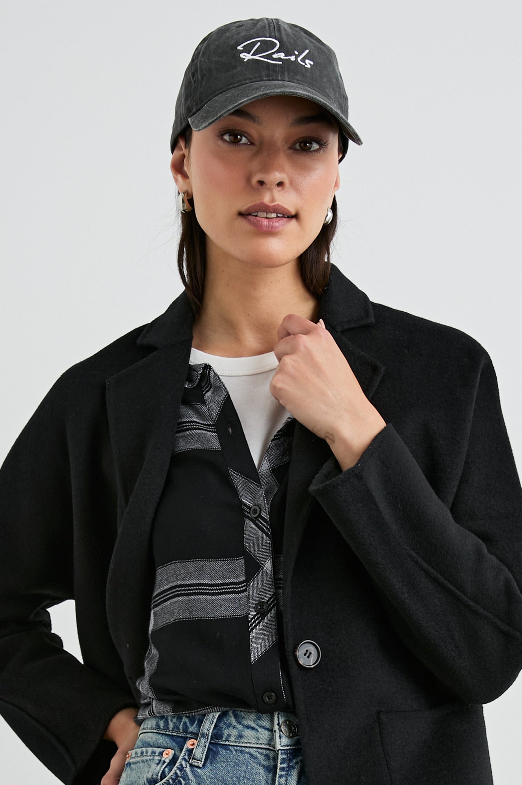 Anniversary Baseball Cap with an Adjustable Back Strap, Front Text, Rails, and Back Text, Est 2009, in Washed Black Colorway, with White Text - Front View Featured on Model