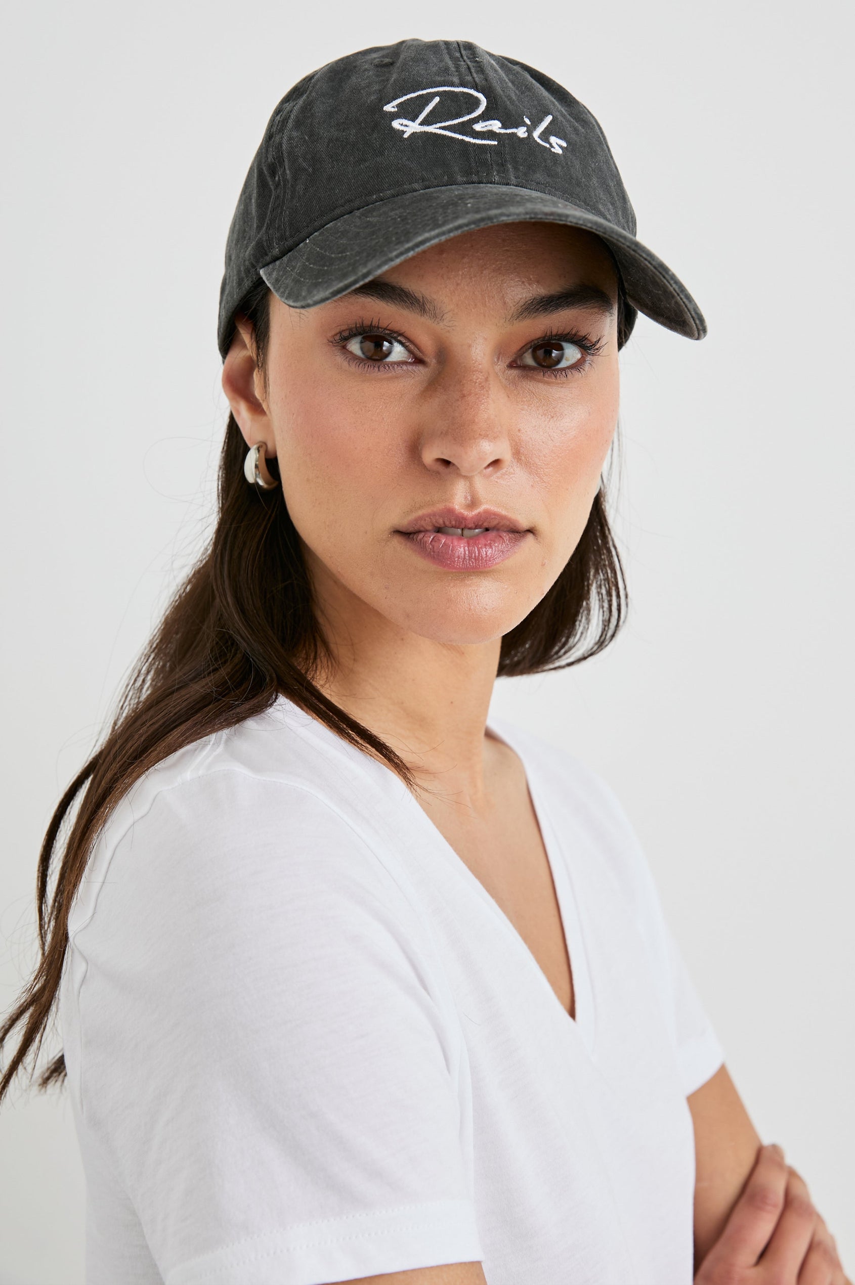 Anniversary Baseball Cap with an Adjustable Back Strap, Front Text, Rails, and Back Text, Est 2009, in Washed Black Colorway, with White Text - Front View Featured on Model