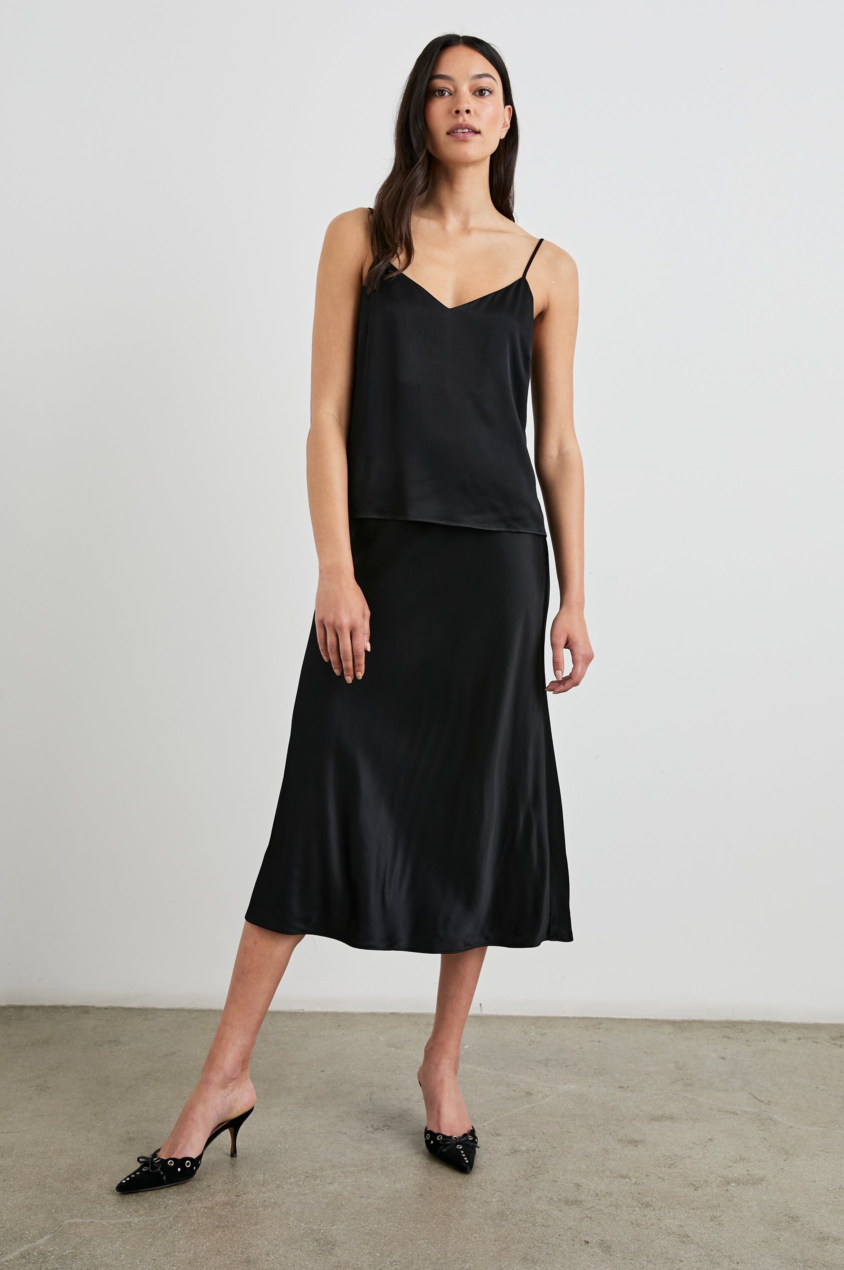 Anya High-waisted Midi Skirt in Black Colorway - Front Full Body View Featured on Model