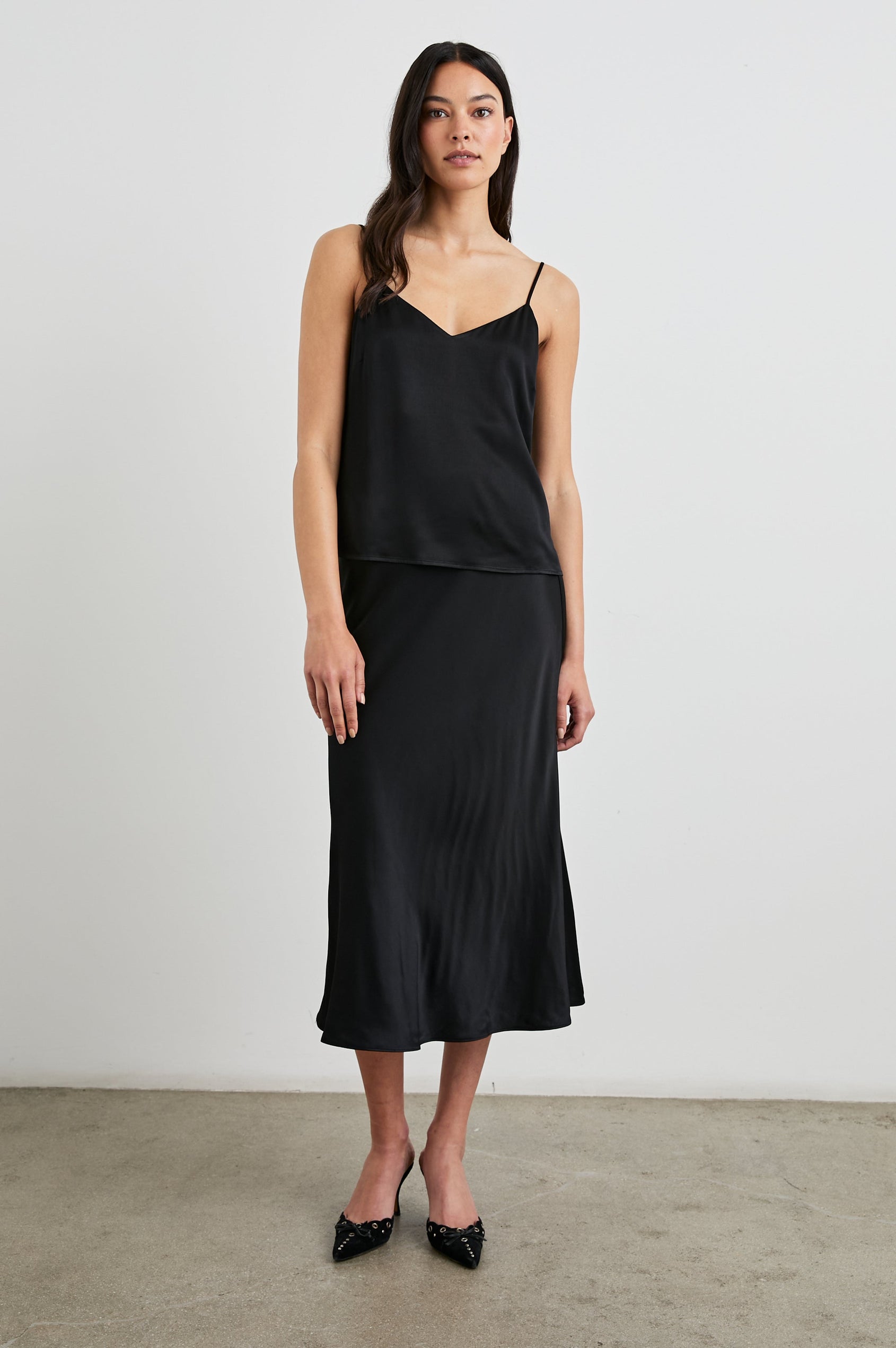 Anya High-waisted Midi Skirt in Black Colorway - Front Full Body View Featured on Model