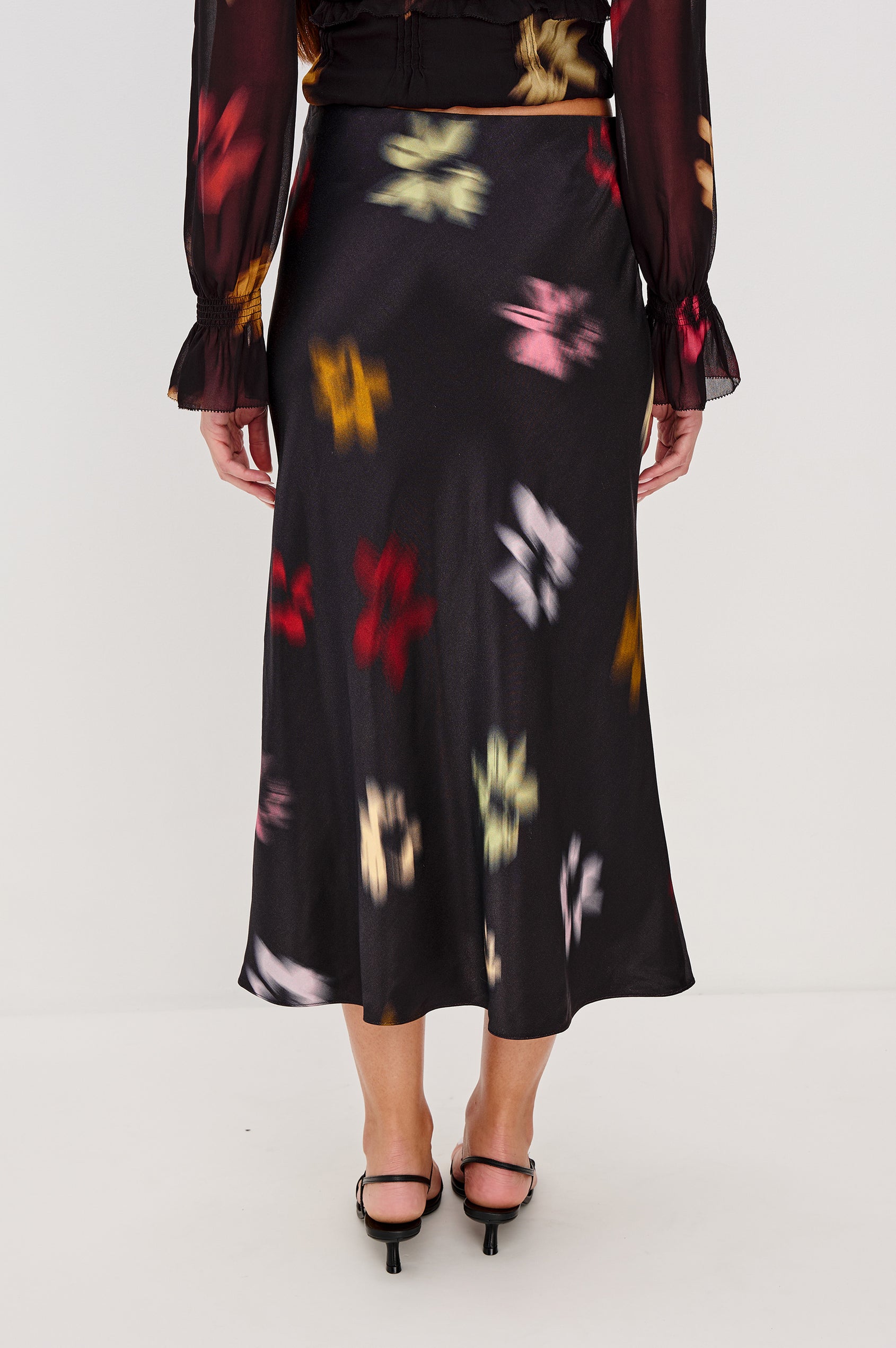 Anya High-waisted Midi Skirt in Onyx Blurred Floral Colorway - Back View Featured on Model, lower half of body
