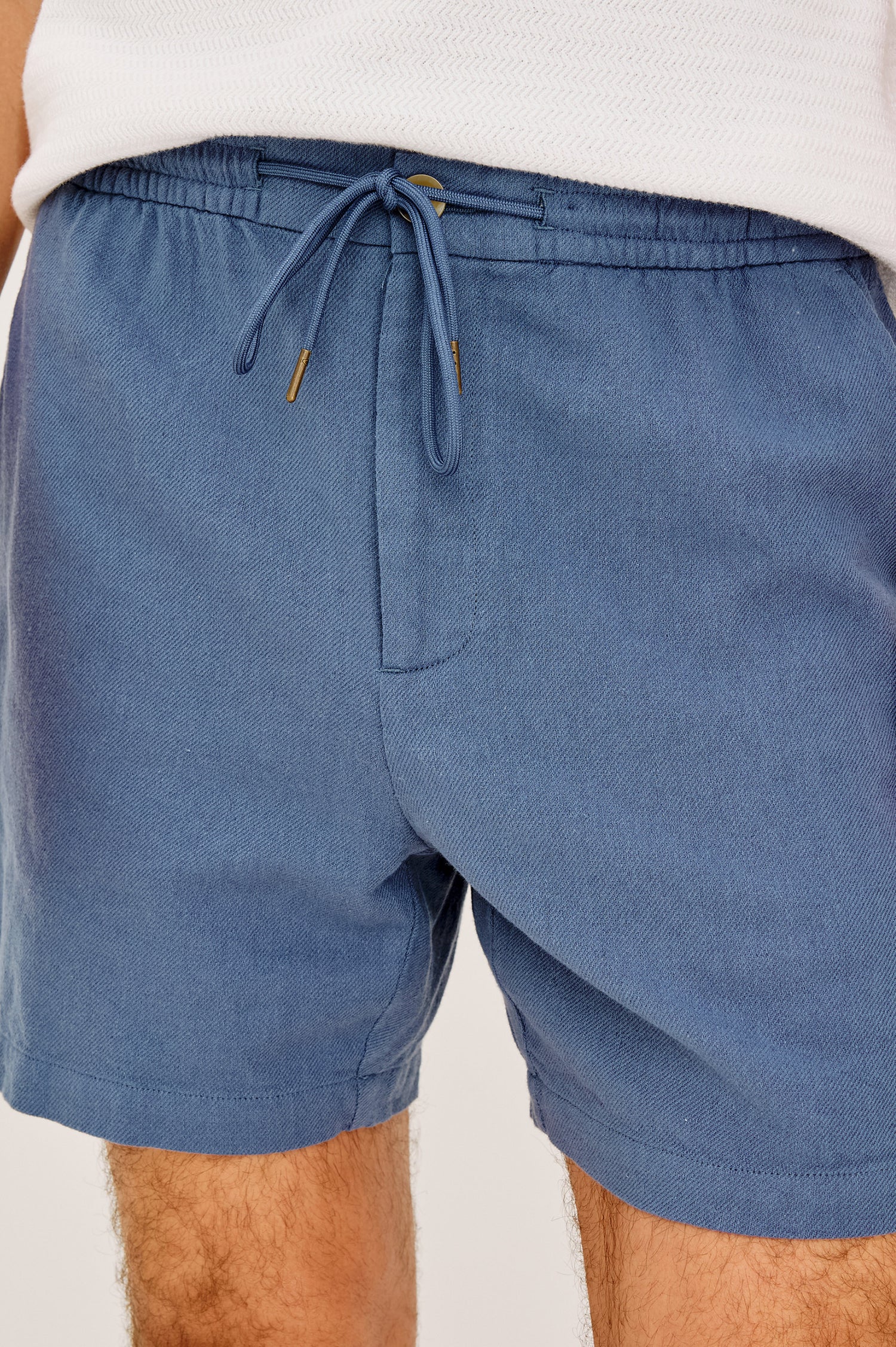 Archer Short in Cotton-Linen Blend With Relaxed Fit, Elastic Drawstring Waist, Front Zip Fly, Side Pockets, and Back Welt Pocket in Washed Blue Colorway - Front View Featured on Model