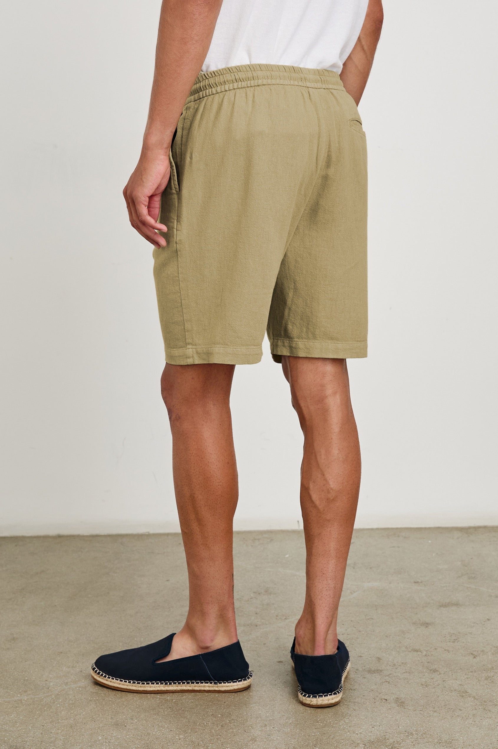 Archer long length cotton short with adjustable drawstring and front button closure in True Khaki - back view on model