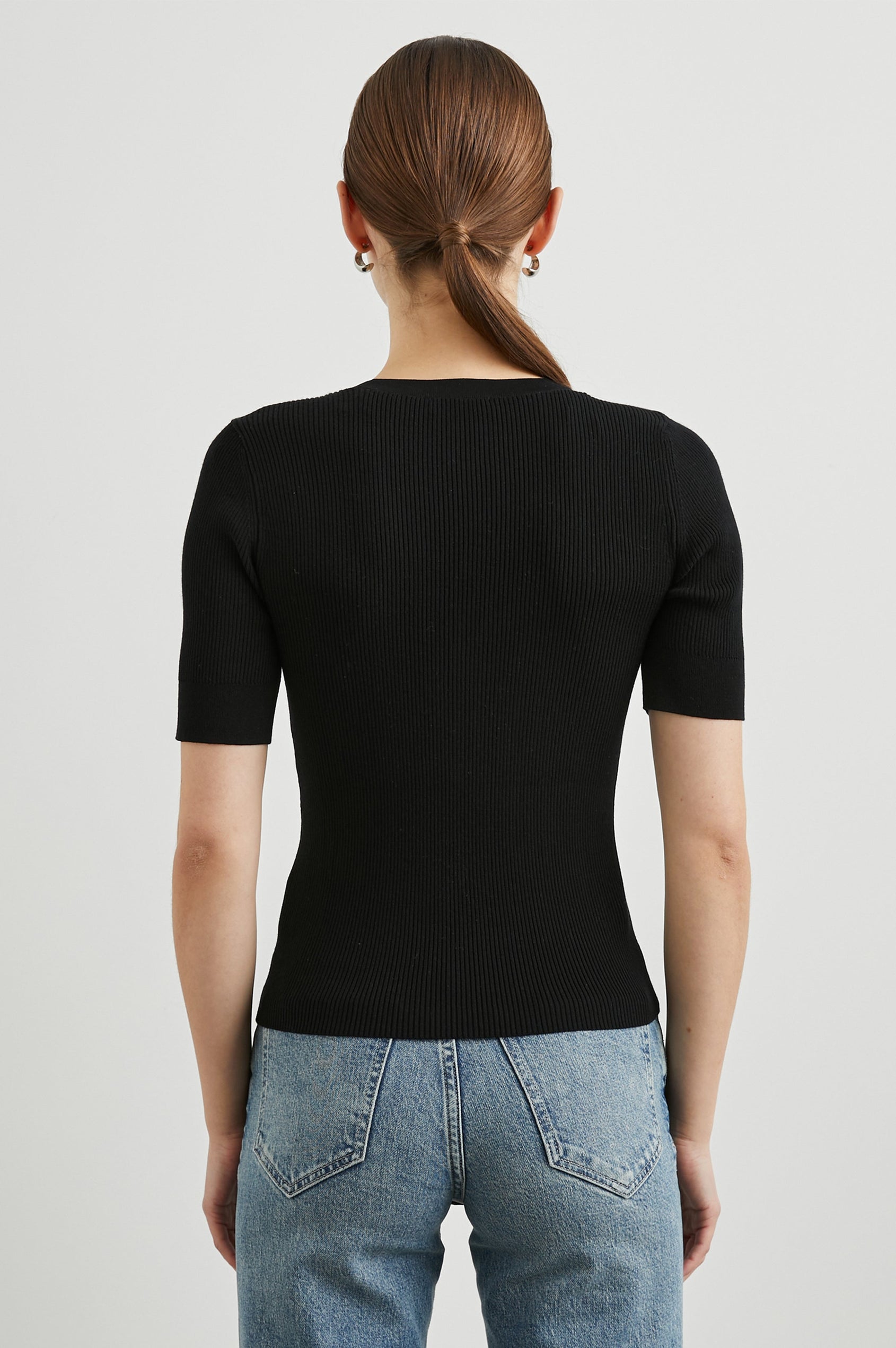 Ari Short-Sleeve Ribbed Top with a Crew Neck in Black Colorway - Back View Featured on Model