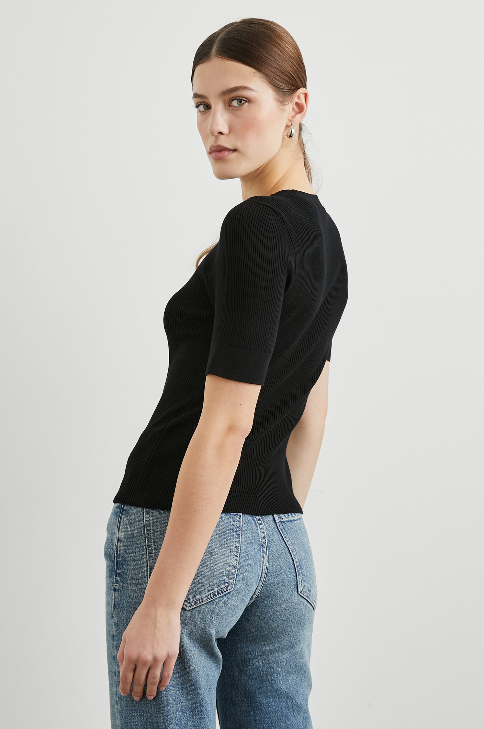 Ari Short-Sleeve Ribbed Top with a Crew Neck in Black Colorway - Back View Featured on Model