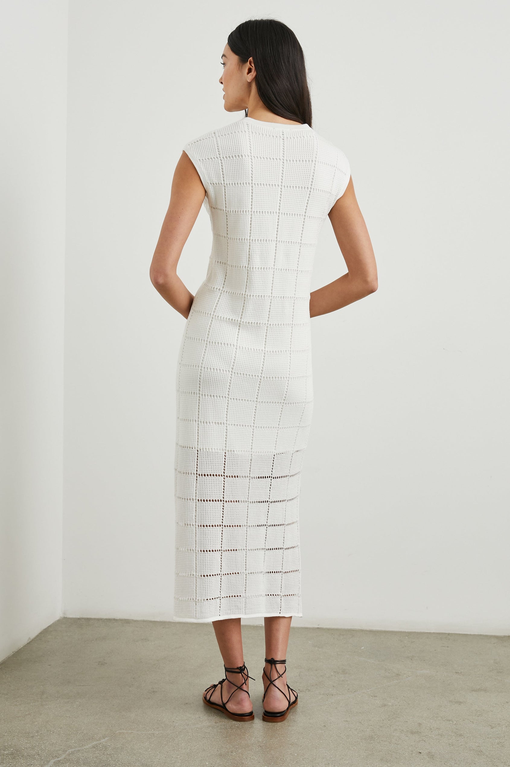 Ashley Short-Sleeve, Open Knit Midi Dress with Cap Sleeves, a V Neck Placket and a Side Slit in White Colorway - Back Full Body View Featured on Model 