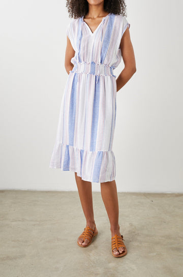 Ashlyn Short Sleeve Midi Dress with a V neck with Ties, a Smocked Waist and a Ruffle Tier at the Hem in Marini Stripe Colorway, Vertical Stripes in Pink and Blue on White - Front Full Body View Featured on Model