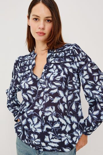 Asta Top in Floral Print Pleated Chiffon With V-Neckline, Inset Ladder Trim at Yoke, and Long Billowing Sleeves With Fitted Cuffs in Navy Jasmine Colorway - Full Body Front View Featured on Model