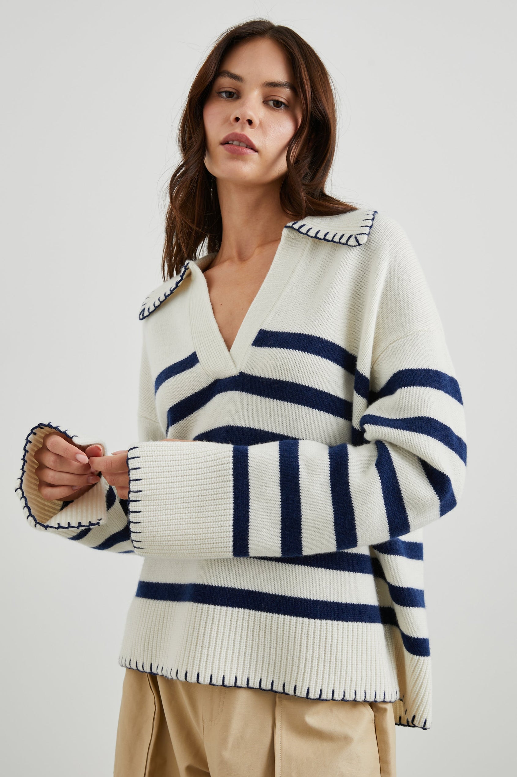 Athena Long-Sleeve Sweater with a Flat Collar V Neckline, Ribbed Cuffs and Hem and Contrast Stitching at the Cuffs and Hem in Ivory Navy Stripe Colorway, Horizontal Stripes - Front View Featured on Model 