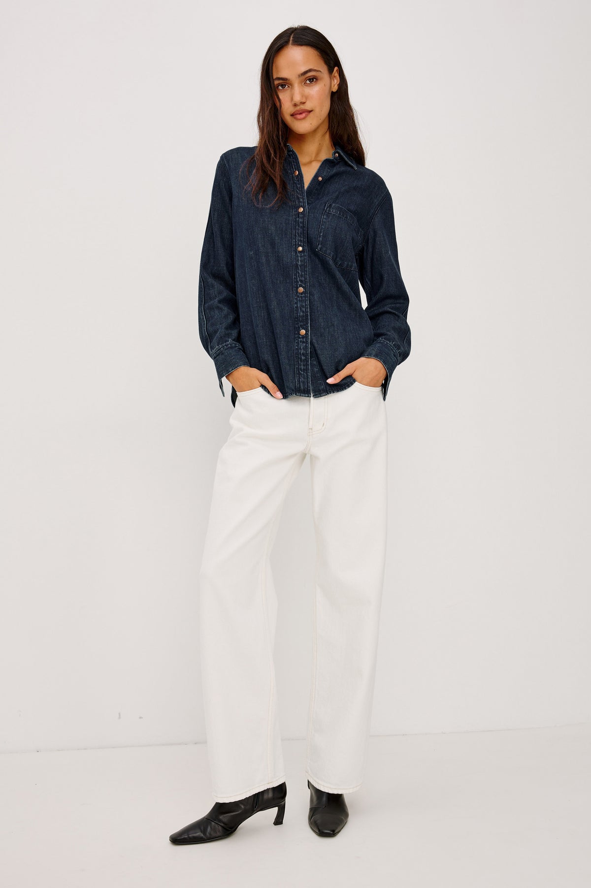 Atticus Shirt in TENCEL Denim With Relaxed Fit, Point Collar, Front Button, and Long Sleeves With Flat-Felled Seams and Buttoned Cuffs in Blue Ridge Colorway - Full Body Front View Featured on Model