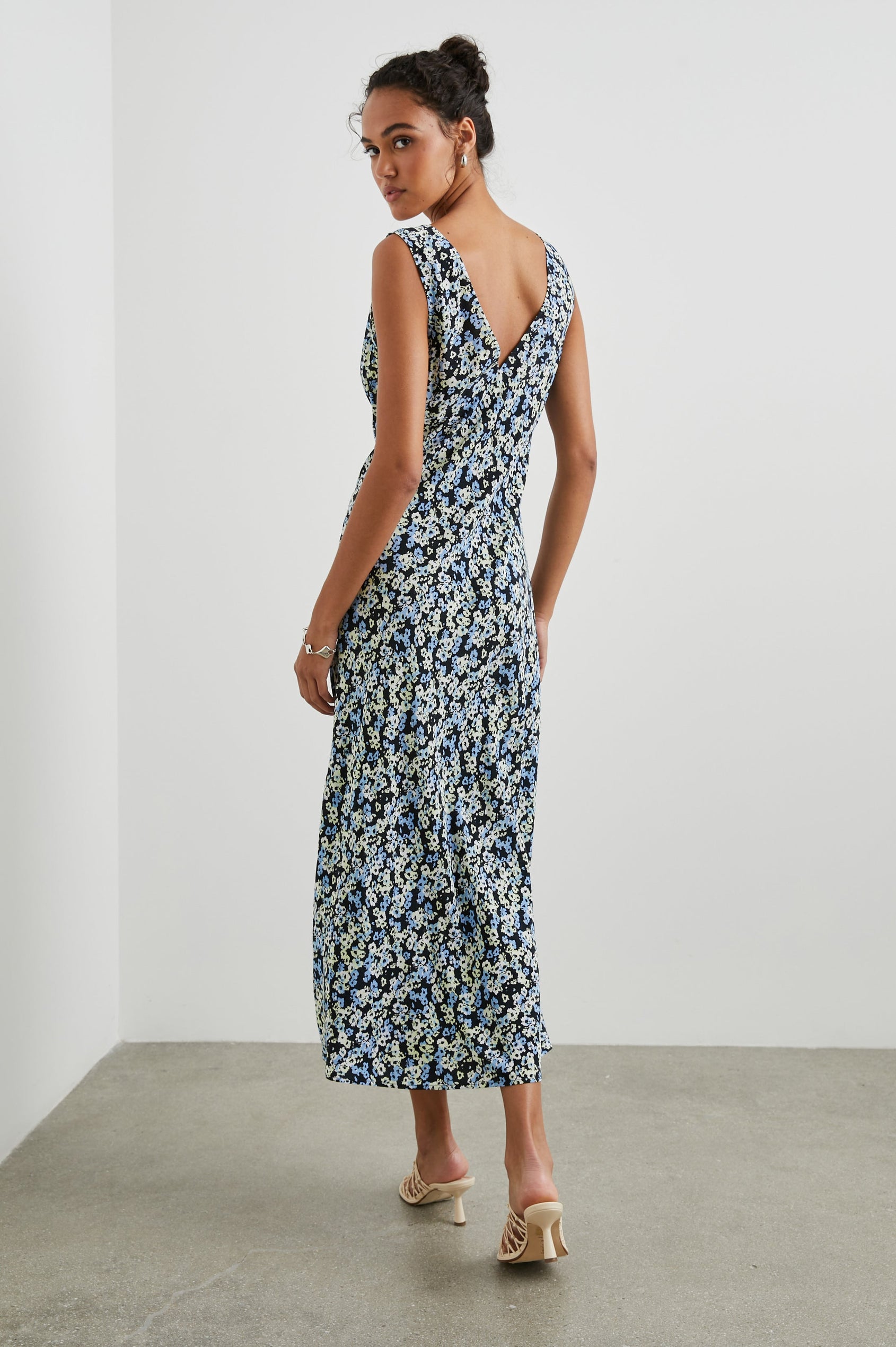 Audrina Sleeveless Midi Dress with Wide Shoulder Straps, a Deep V Neck and V-Back, and an Empire Waist in Midnight Meadow Floral Colorway, cream and blue flowers on Midnight - Back Full Body View Featured on Model 