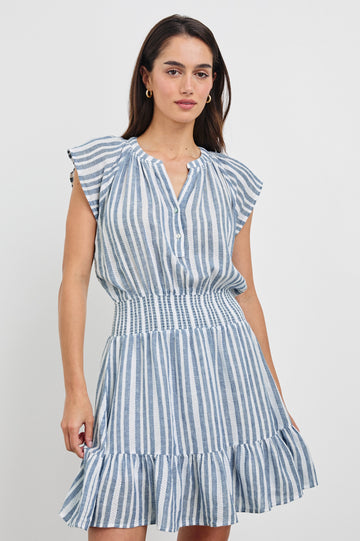 Augustine Mini Dress with Flutter Sleeves, V-Neck Button Front, Elastic Gathered Waist and a Tiered Flounce Hem in Jalisco Stripe Colorway. Front View Shown on Model.