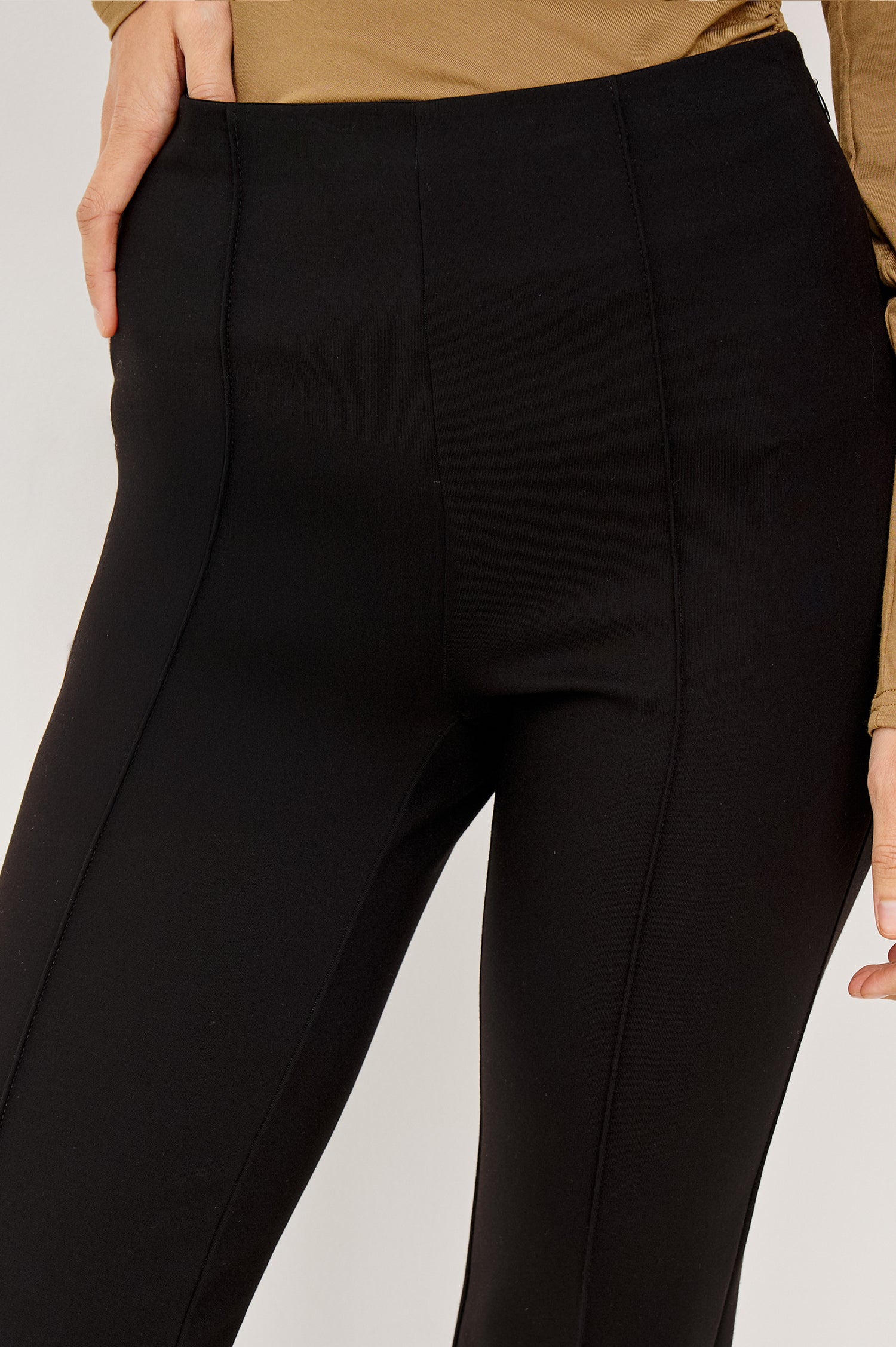 Auray High-Waisted Pant in Ponte With Pintuck Front Seams, Cropped Legs, Elastic Waistband, and Kick Flare in Black Colorway - Lower Body Close Up Front View Featured on Model