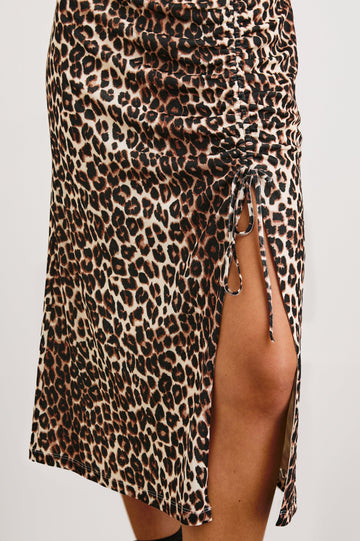 Auren Midi Dress with Cap Sleeves, a Deep V Neck, a Mid-Thigh Side Slit and Ruching from the V Neck to the Slit with a Drawcord at the Slit in Nala Colorway, Black and Brown Spots on Tan - Front View Featured on Model 