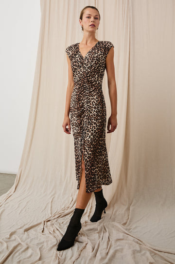 Auren Midi Dress with Cap Sleeves, a Deep V Neck, a Mid-Thigh Side Slit and Ruching from the V Neck to the Slit with a Drawcord at the Slit in Nala Colorway, Black and Brown Spots on Tan - Front Full Body View Featured on Model 