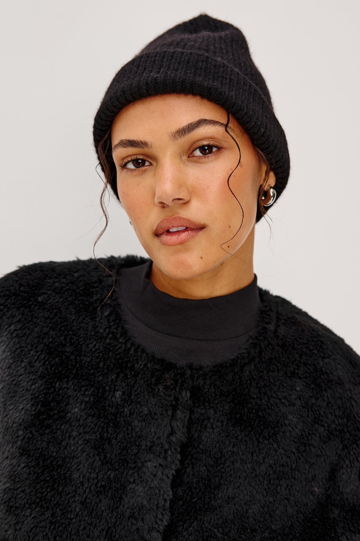 Autumn Cashmere Silk Cuffed Beanie in Black Colorway. Front View Featured on Model.