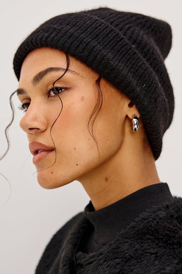 Autumn Cashmere Silk Cuffed Beanie in Black Colorway. Side View Featured on Model.