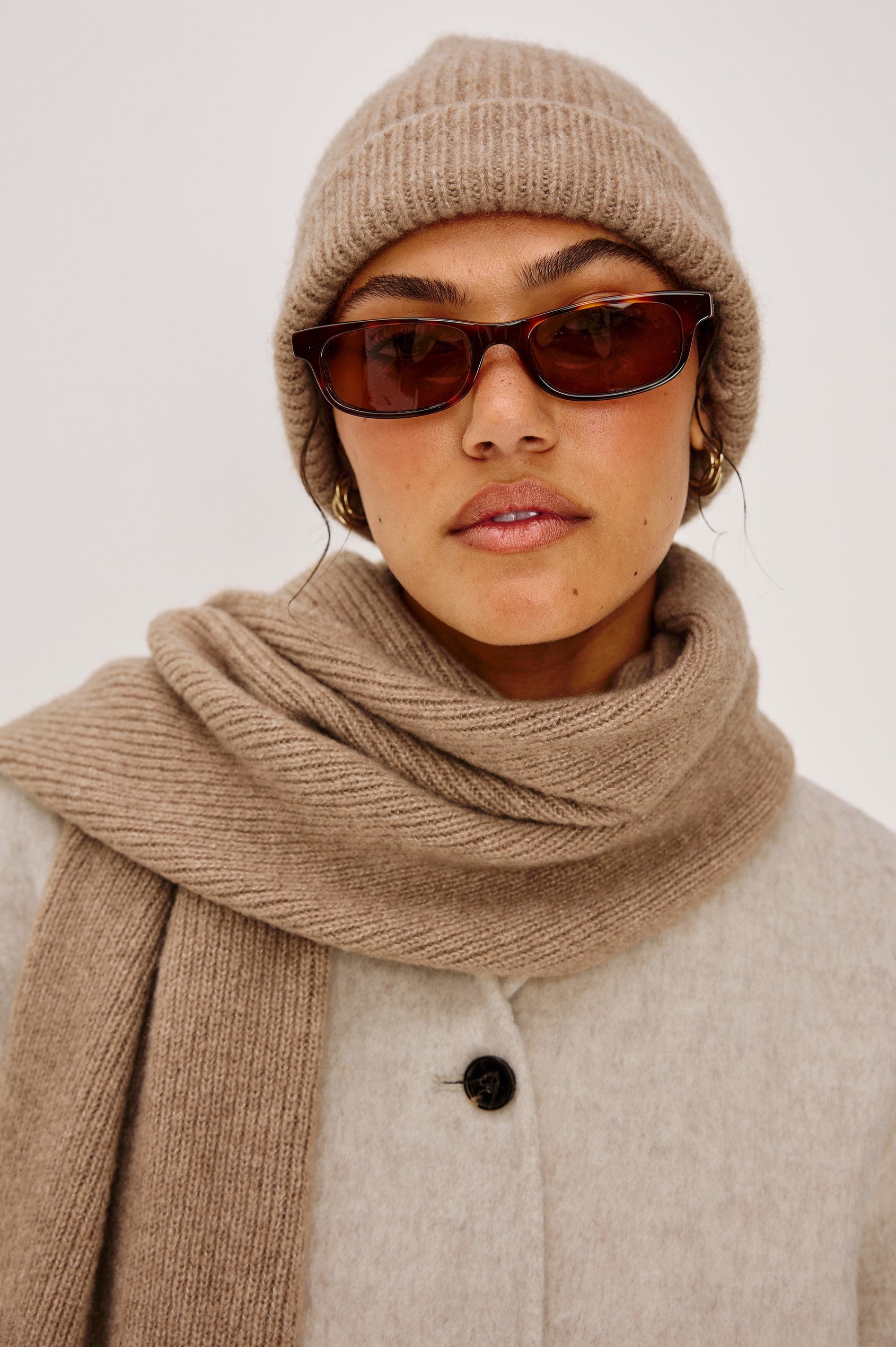 Autumn cashmere beanie in Oat colorway. Front view featured on model.