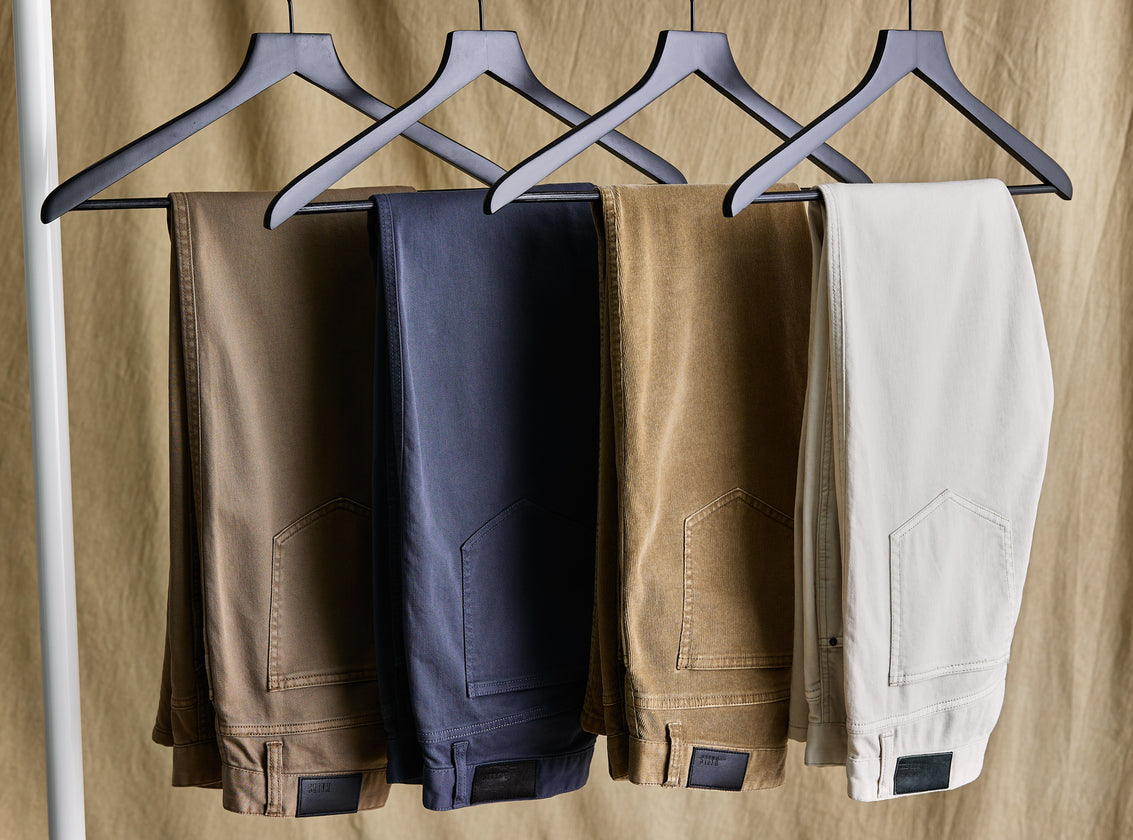 EDITORIAL IMAGE OF CARVER PANTS HANGING ON A CLOTHING RACK