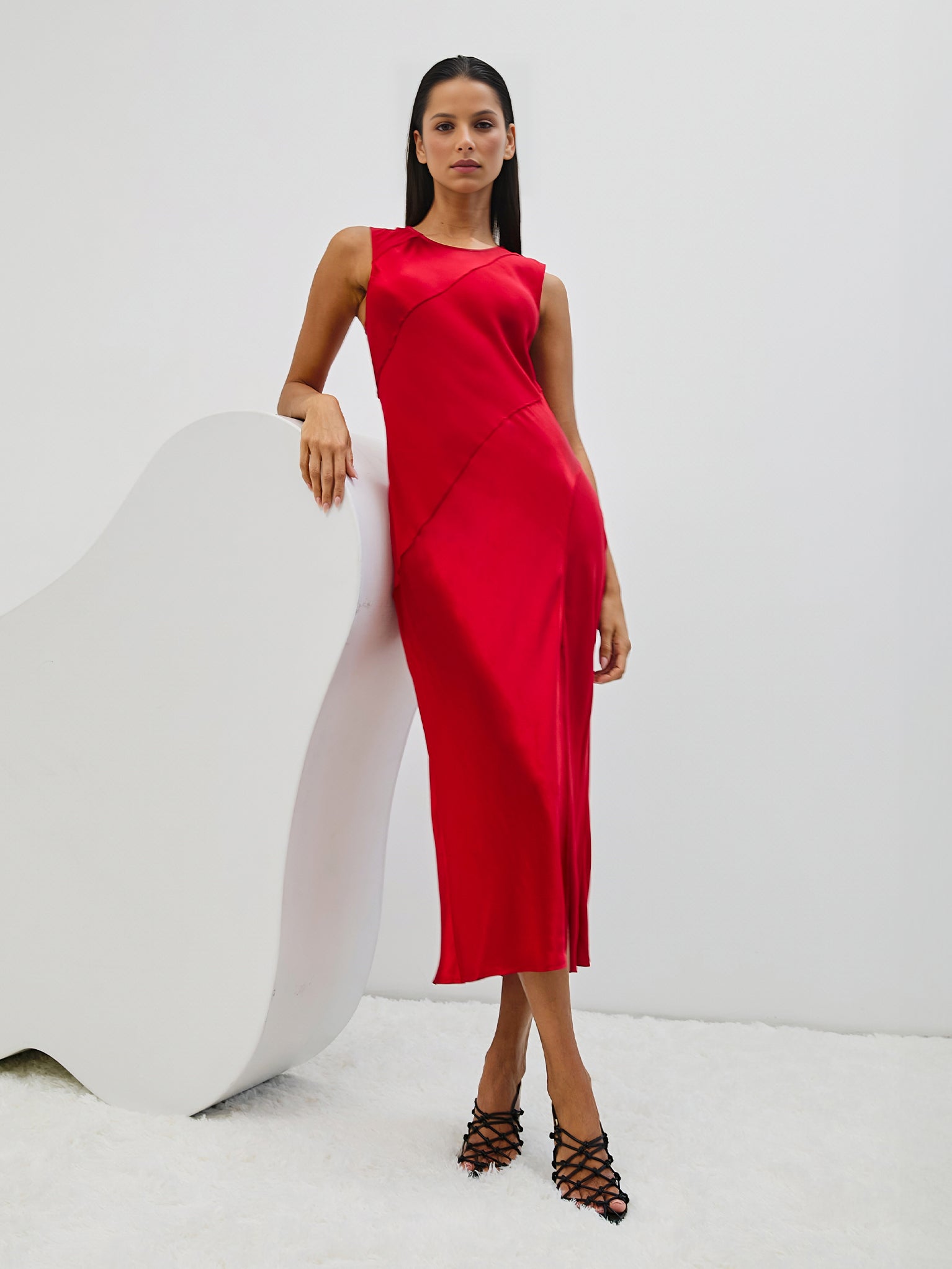 TWO SIDE BY SIDE EDITORIAL IMAGES OF MODEL WEARING SANYA DRESS IN SCARLET