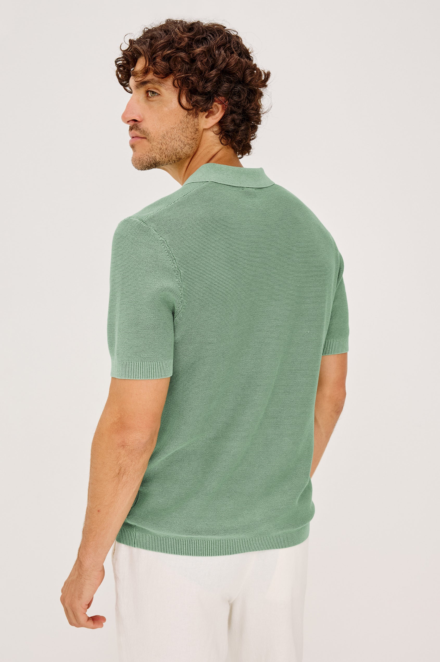 Baker Polo Shirt in Rib Cotton Knit With Colar, Short Sleeves, and Relaxed Fit in Vetiver Colorway - Upper Body Back View Featured on Model