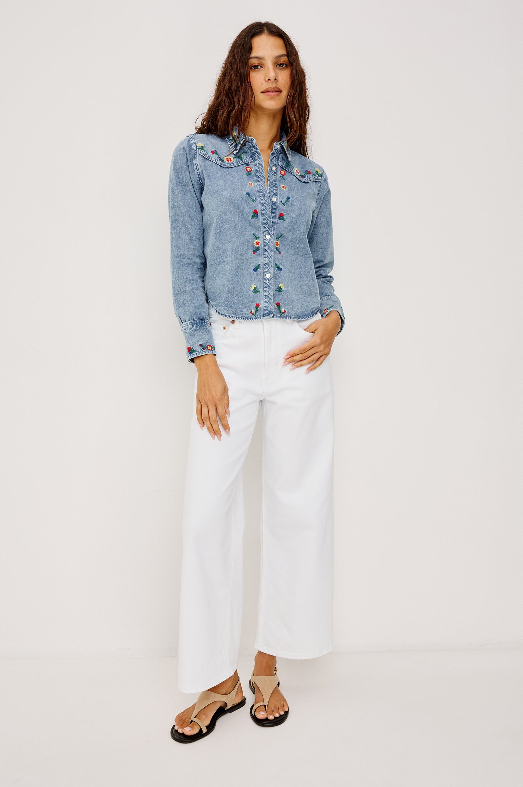 Bari Shirt in Cotton Chambray With Collar, Front Buttons, and Long Sleeves in Indigo Floral Embroidery Colorway - Full Body Front VIew Featured on Model