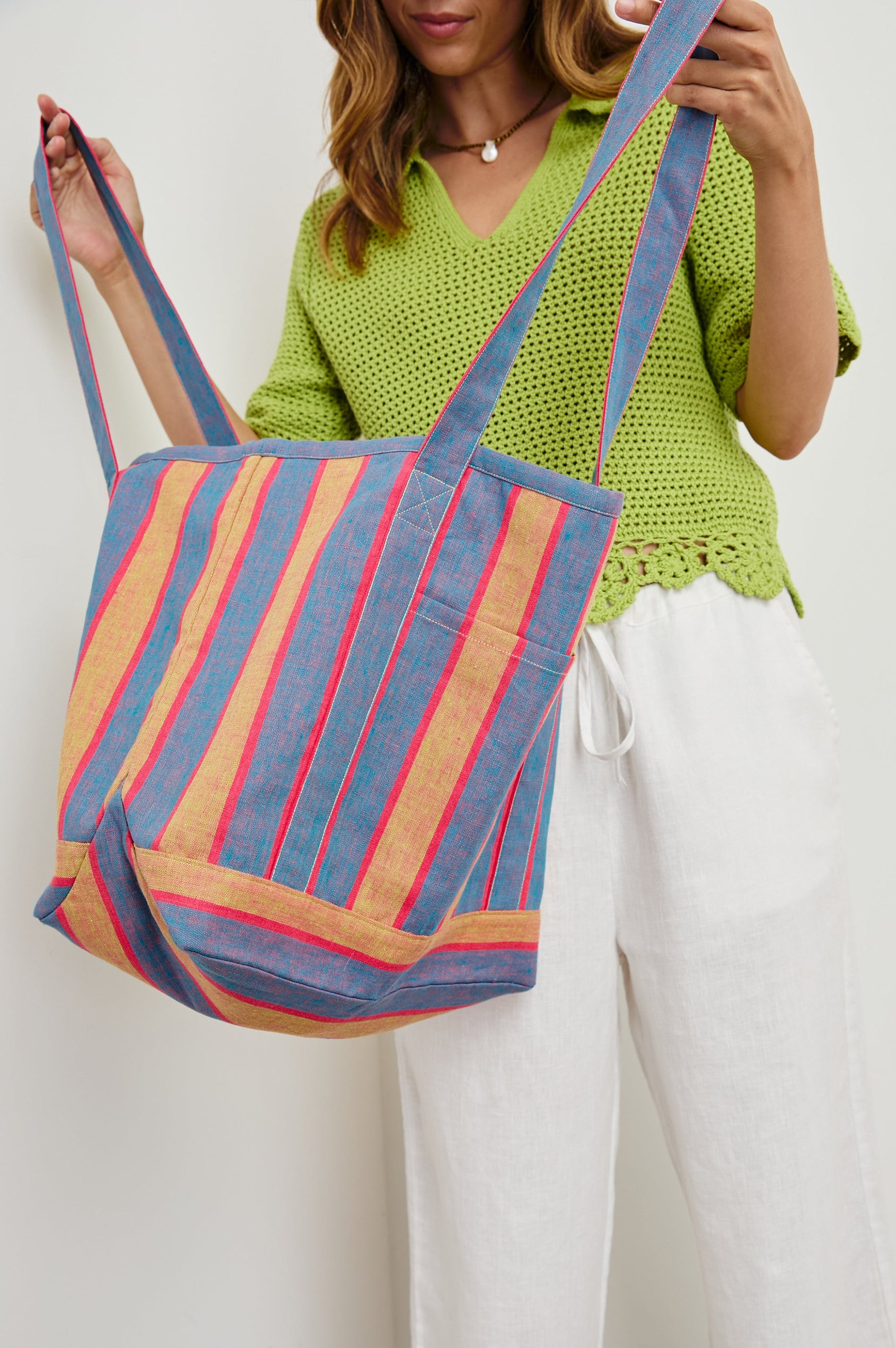Striped linen Beach Tote with front pocket and long, wide shoulder straps in Rio Stripe - close up of bag, model opening bag