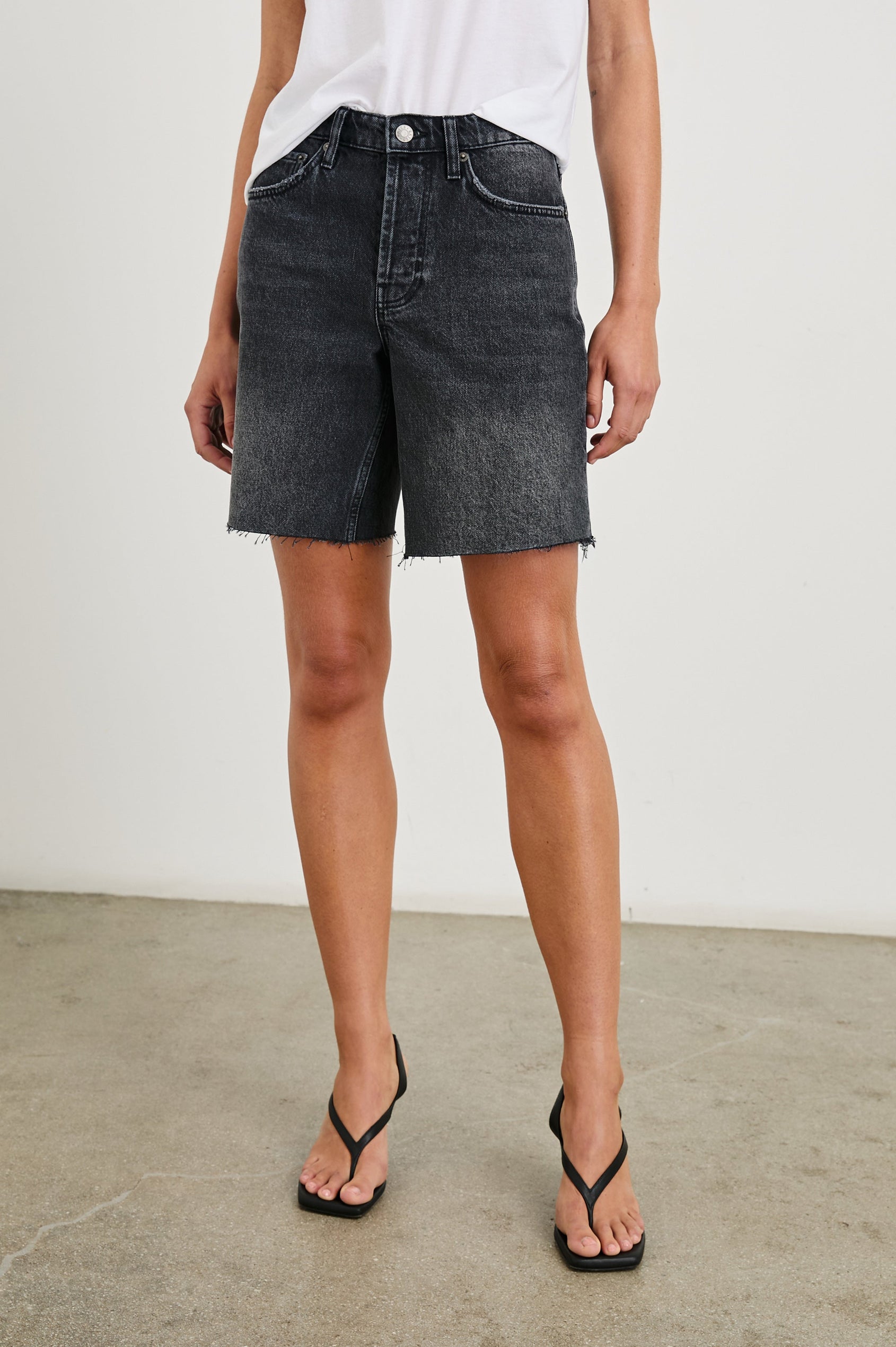 Beachwood high rise bermuda length denim short in dark wash Black Smoke - front view on model, lower half of body