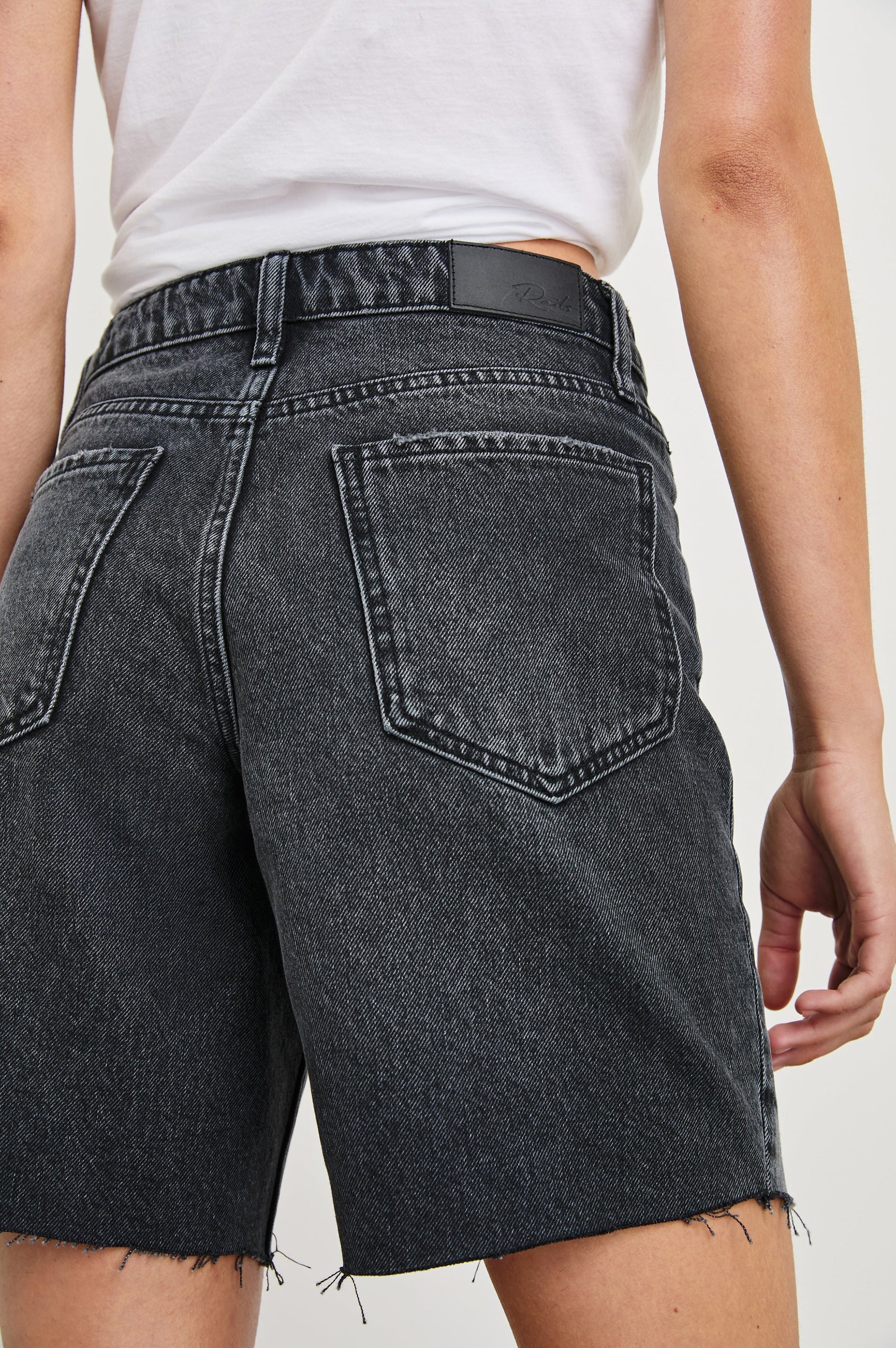 Beachwood high rise bermuda length denim short in dark wash Black Smoke - close up of back details on model