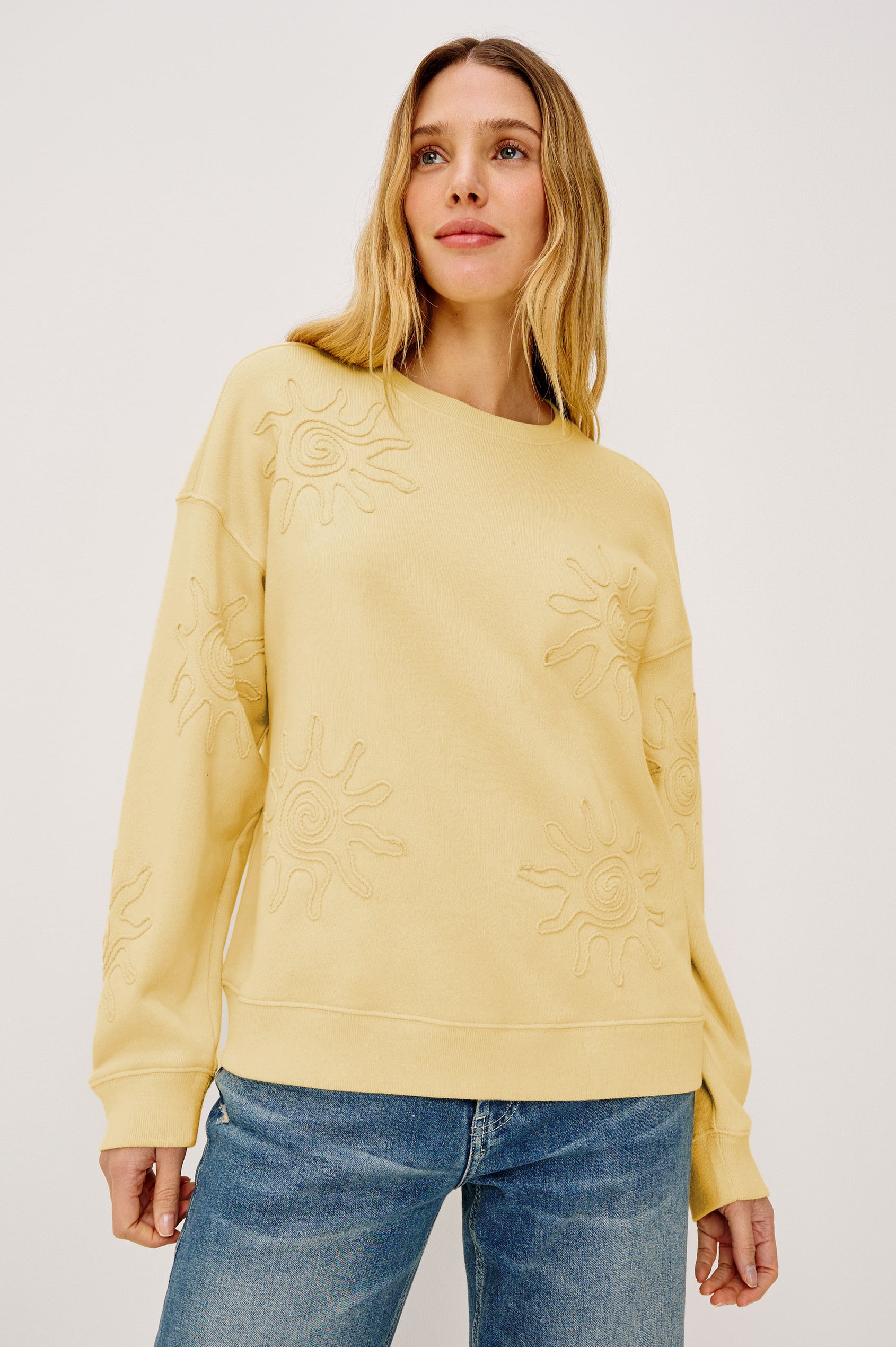 Beckley Sweatshirt in French Terry With Soutached Suns, Relaxed Fit, and Long Sleeves in Sunshine Colorway - Upper Body Front View Featured on Model