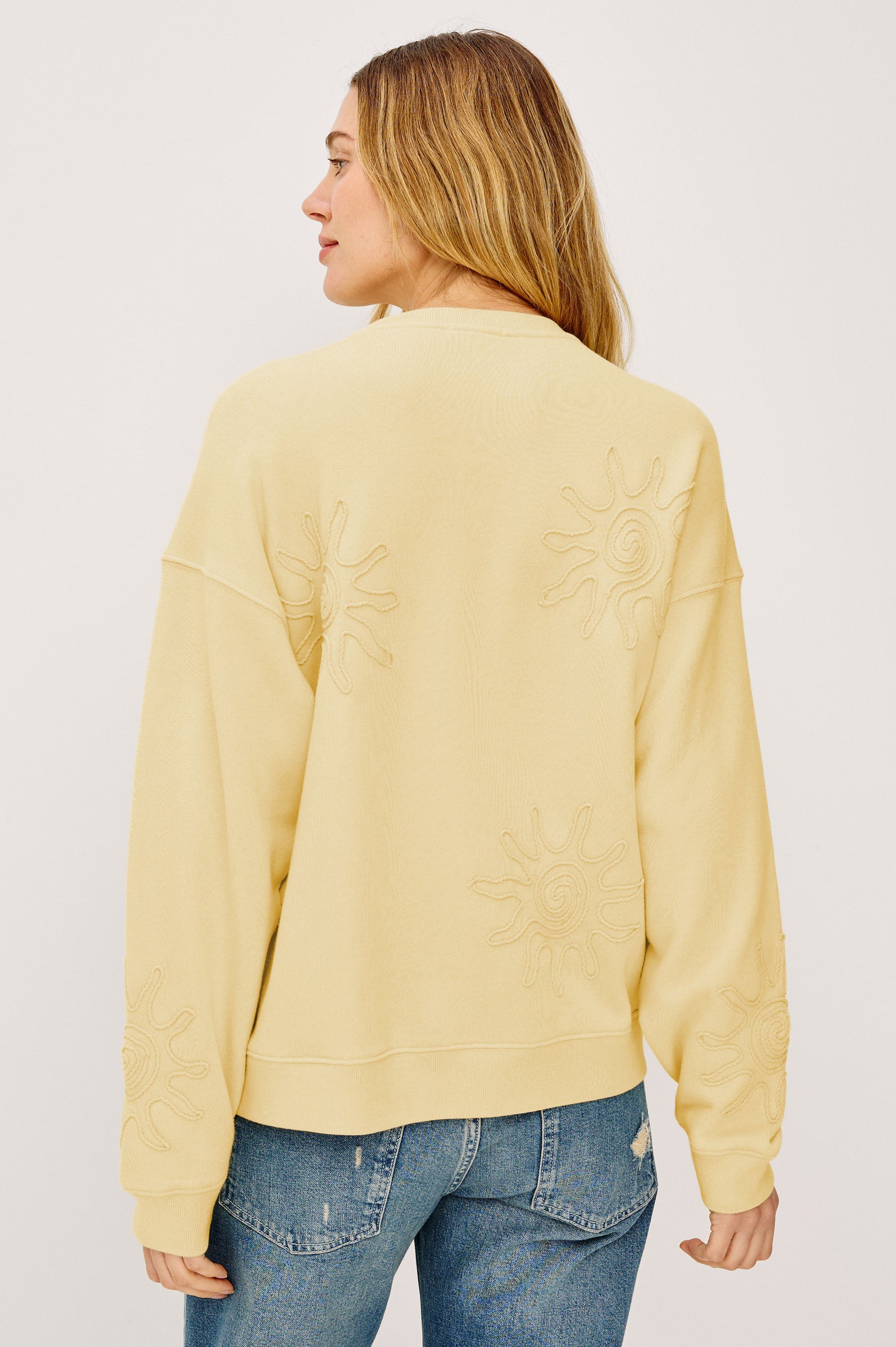 Beckley Sweatshirt in French Terry With Soutached Suns, Relaxed Fit, and Long Sleeves in Sunshine Colorway - Upper Body Back View Featured on Model