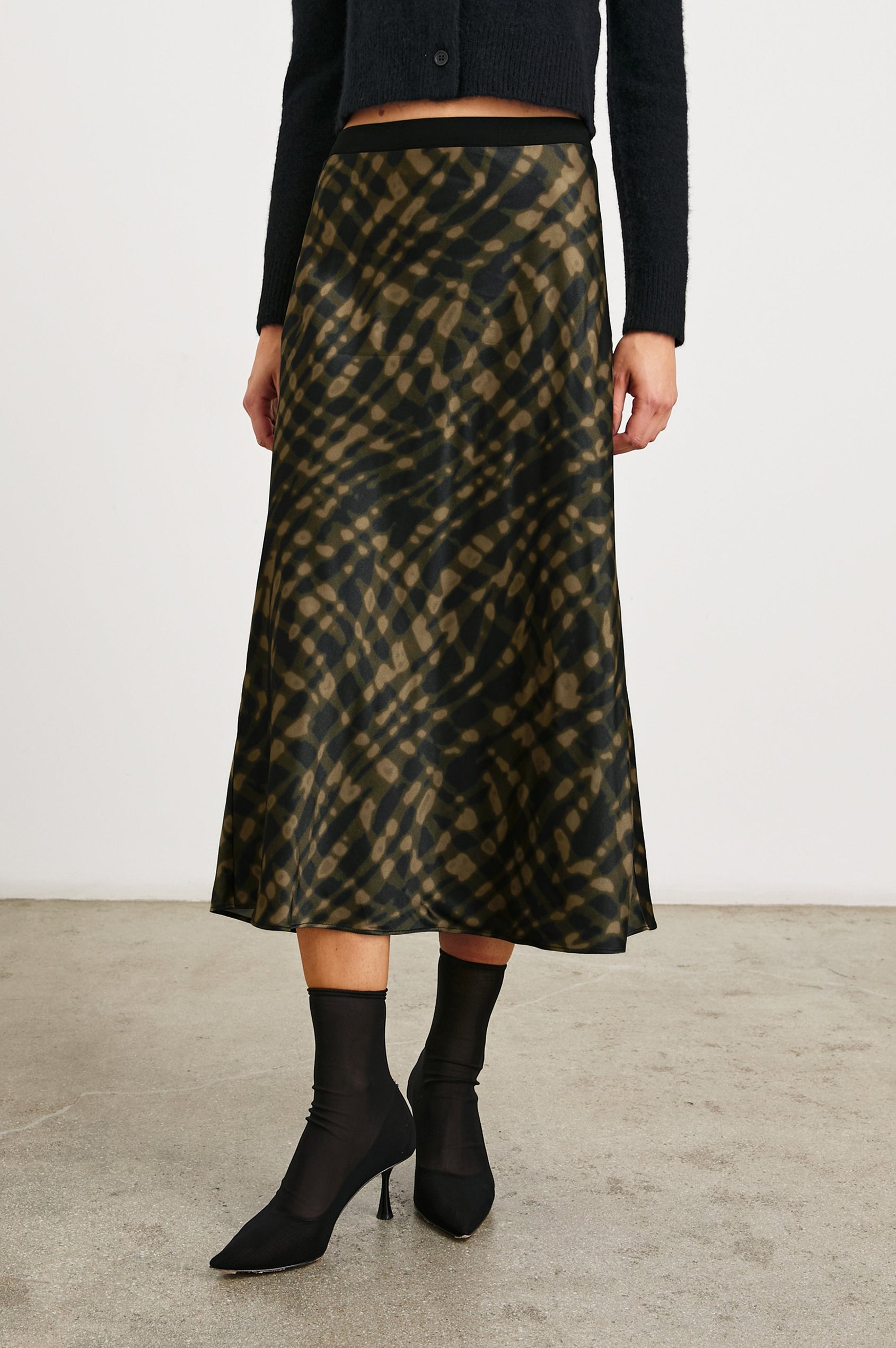 Berlin Midi Skirt in Cypress Colorway, a Black and Cypress Pattern - Front View Featured on Model