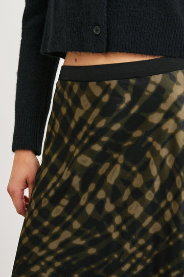 Berlin Midi Skirt in Cypress Colorway, a Black and Cypress Pattern - Front View Featured on Model