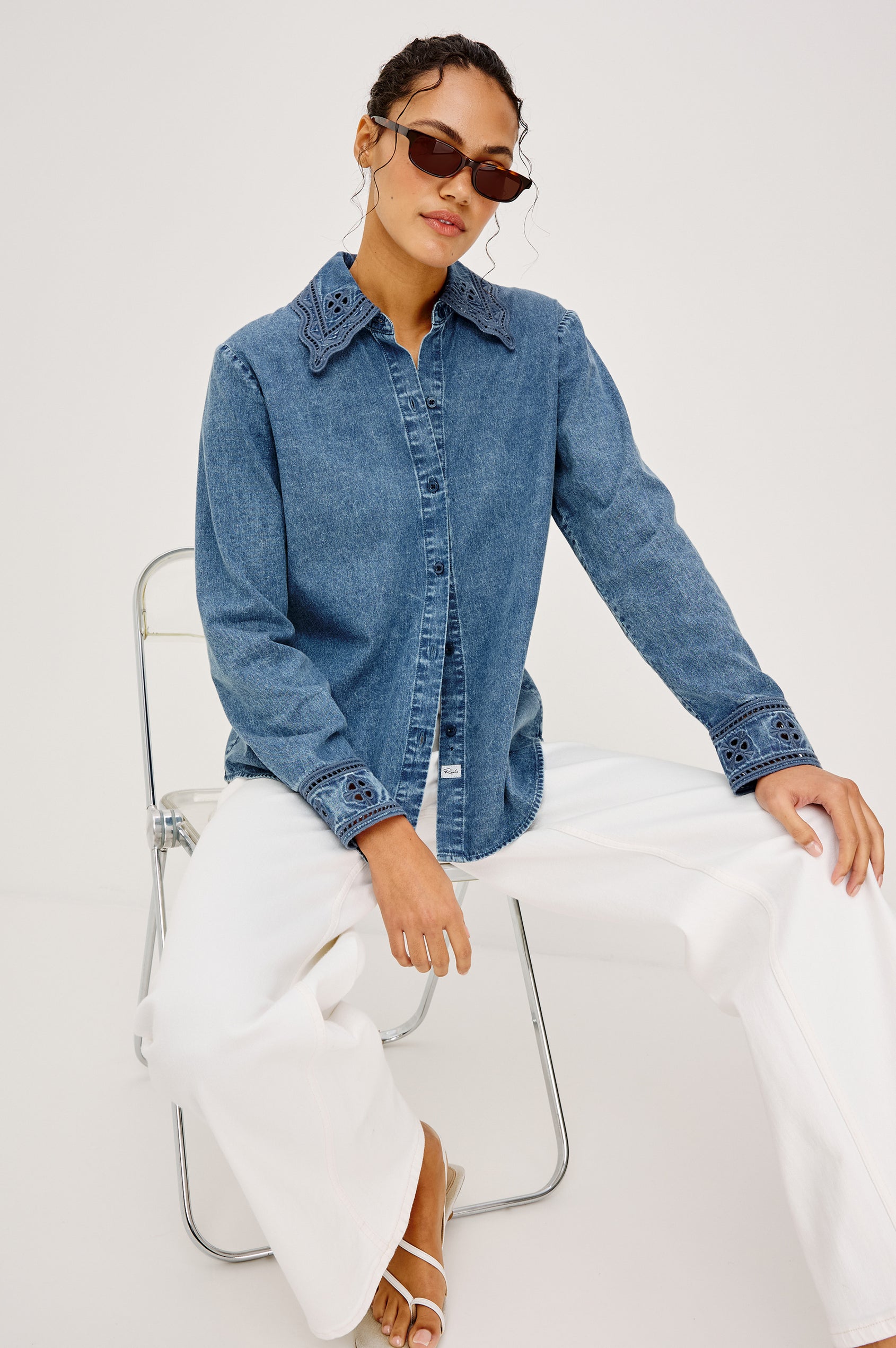 Bethany Button-Up Shirt in TENCELâ„¢ Denim With an Embroidered Collar Long Sleeves and Loose Fit in Antique Blue Colorway - Full Body View Featured on Model Sitting