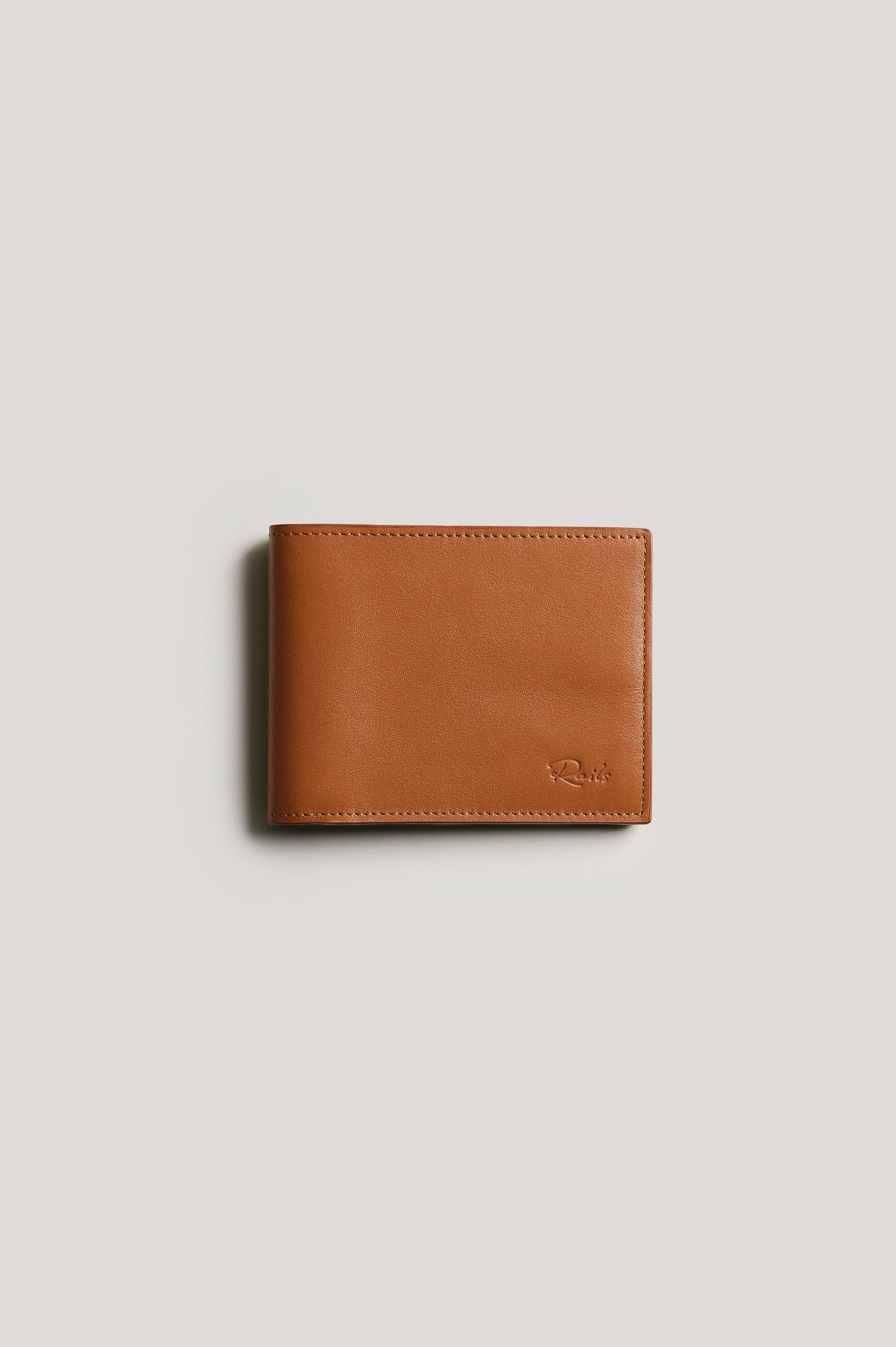 Leather wallet in cognac color, folded. Front view featured.