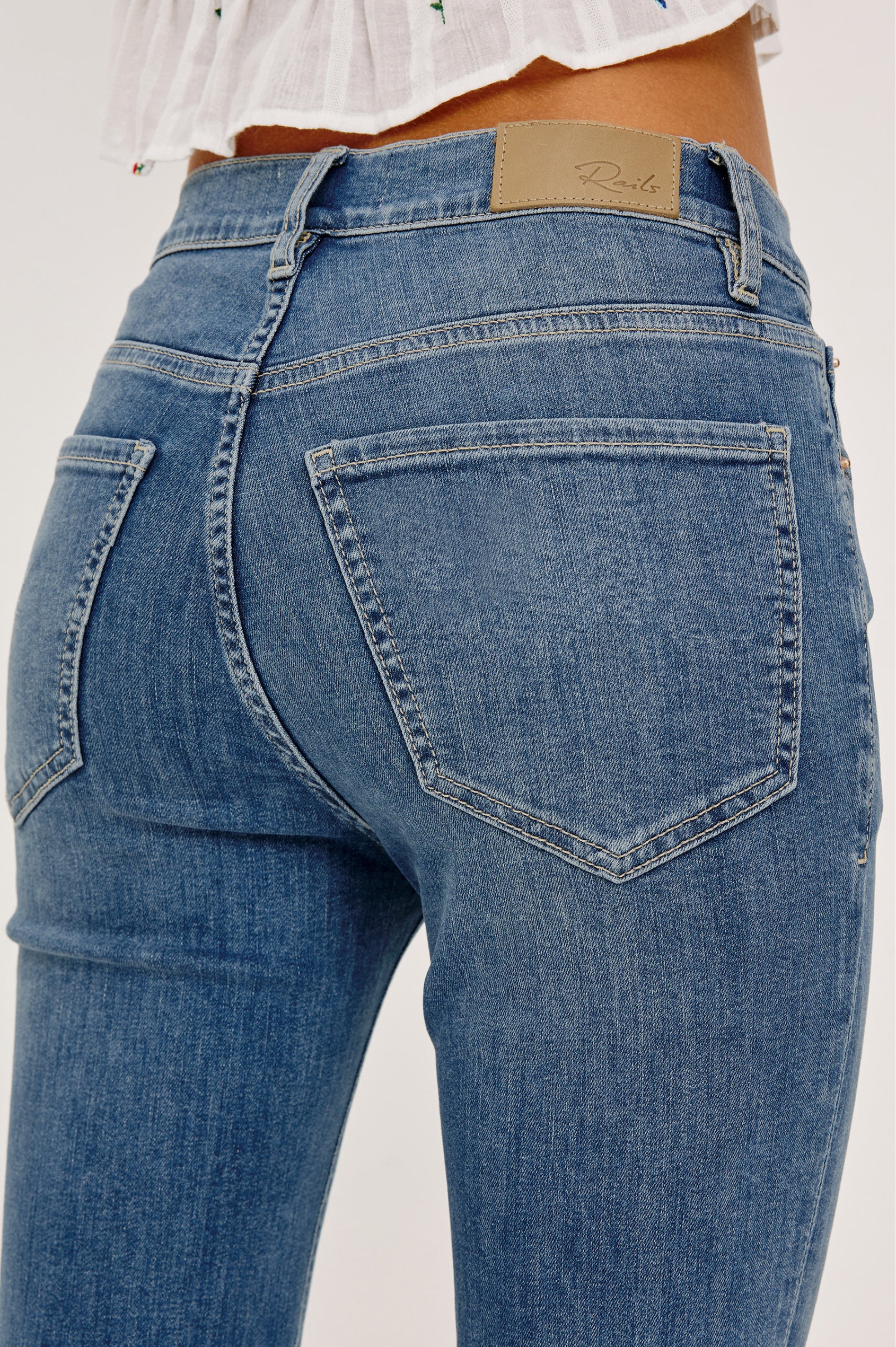 Bixby Mid-Rise Slim Straight Jean in High Stretch Denim With 28″ Inseam, Zip Fly, and 5-Pockets in East Coast Colorway - Lower Body Back View Featured on Model