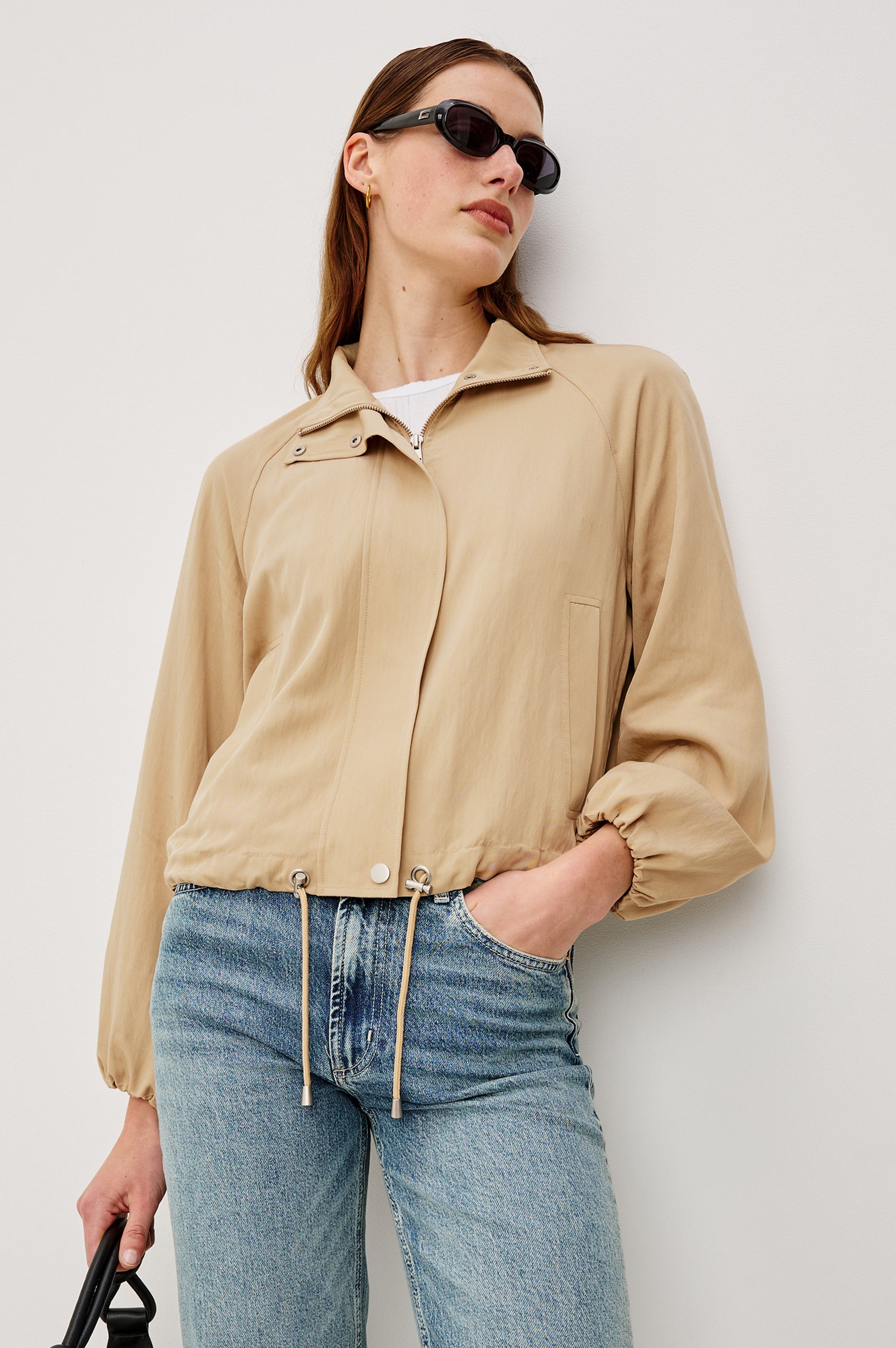 Blake Oversized Cropped Jacket With High Funnel Neck, Double-Button Closures, Long Drop Shoulder Sleeves With Elastic Cuffs, Side Pockets, and Drawstring Hem in Almond Colorway - Upper Body Front View Featured on Model