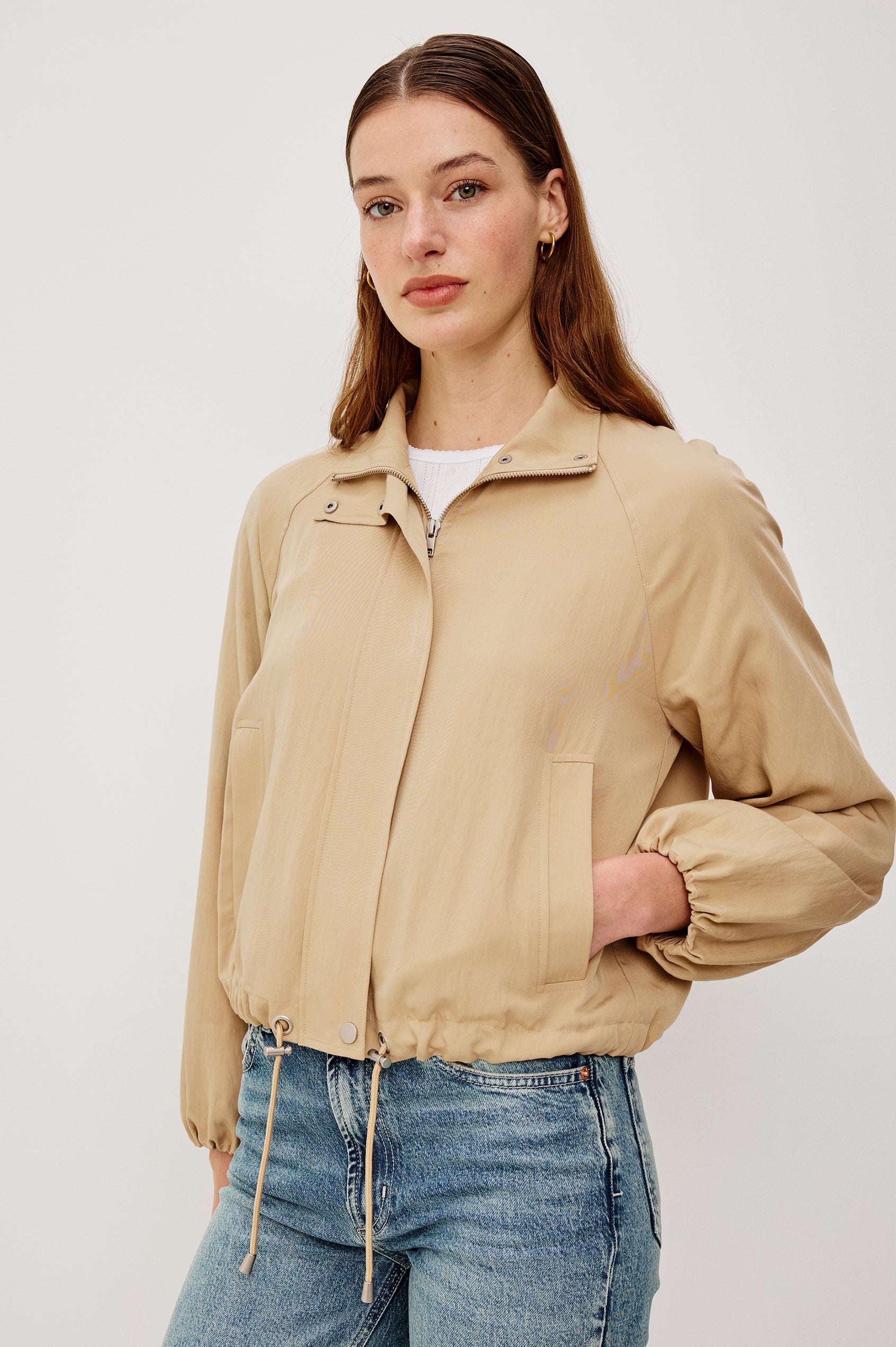 Black Jacket With Oversized Relaxed Fit, High Funnel Neck, Dropped Shoulders, Long Sleeves, Center-Front Ties, Side-Seam Zipper in Almond Colorway - Upper Body Front View Featured on Model
