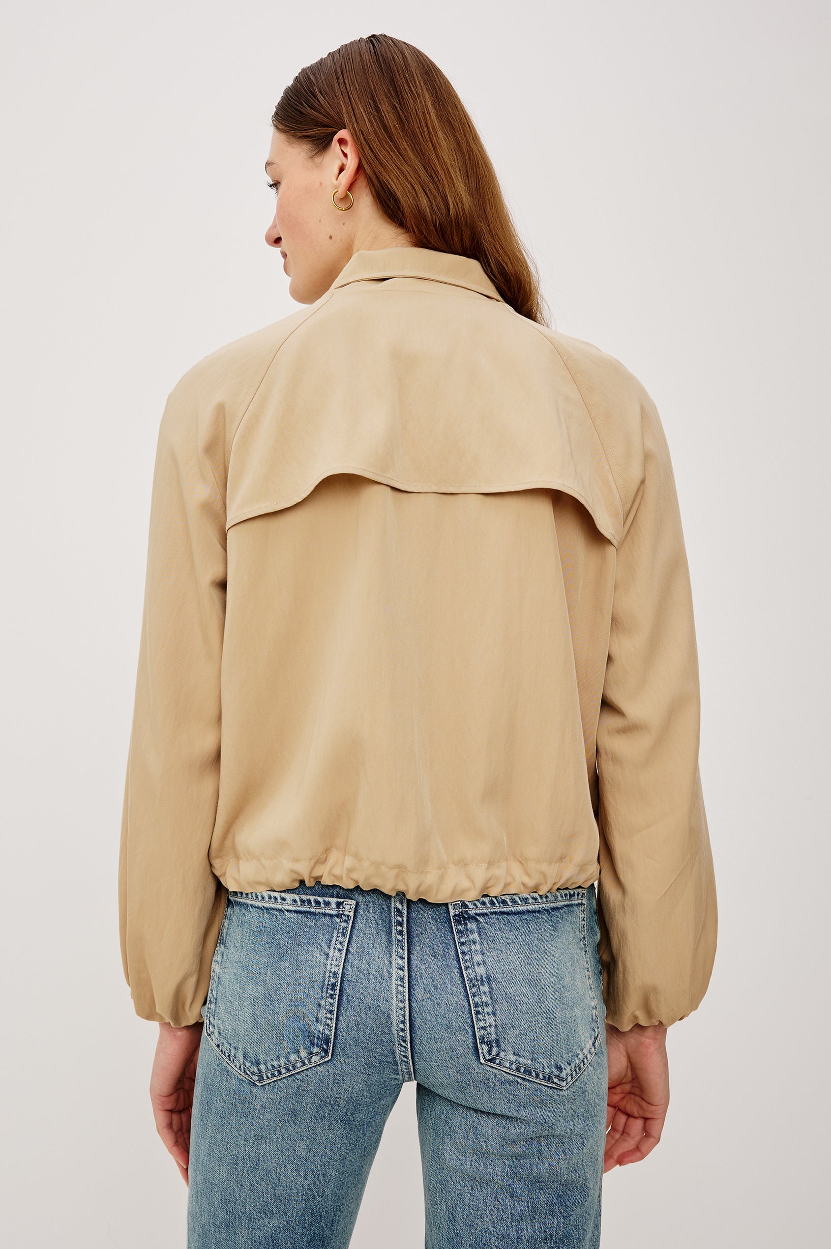 Blake Oversized Cropped Jacket With High Funnel Neck, Double-Button Closures, Long Drop Shoulder Sleeves With Elastic Cuffs, Side Pockets, and Drawstring Hem in Almond Colorway - Upper Body Back View Featured on Model